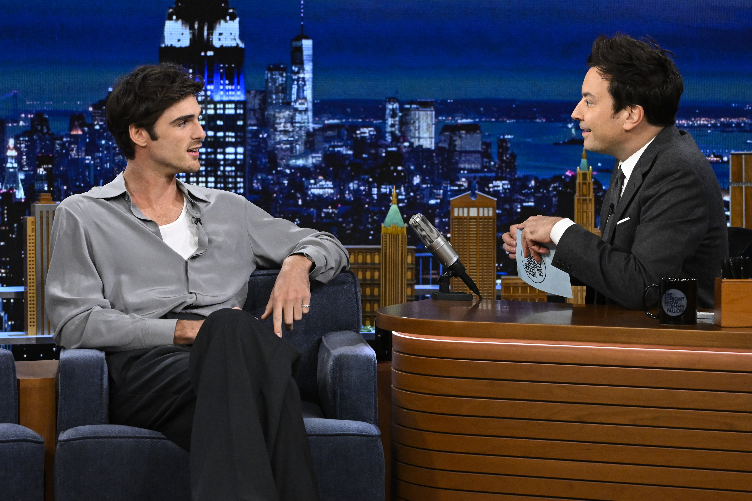 Close-up of Jacob seated and smiling and talking to Jimmy Fallon