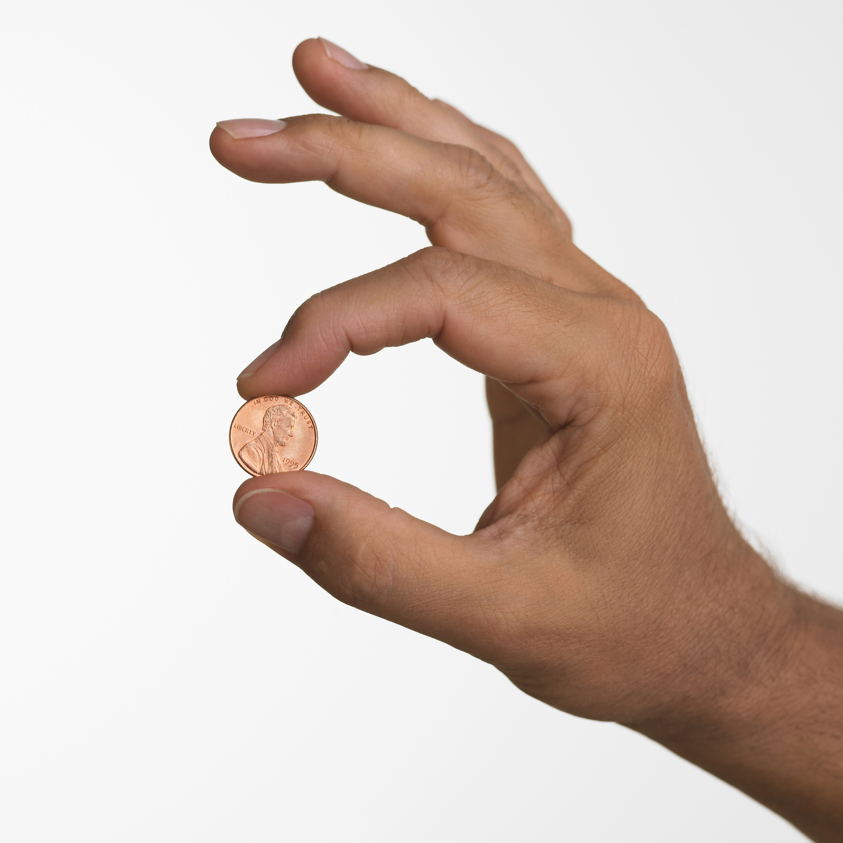 A hand holding a penny