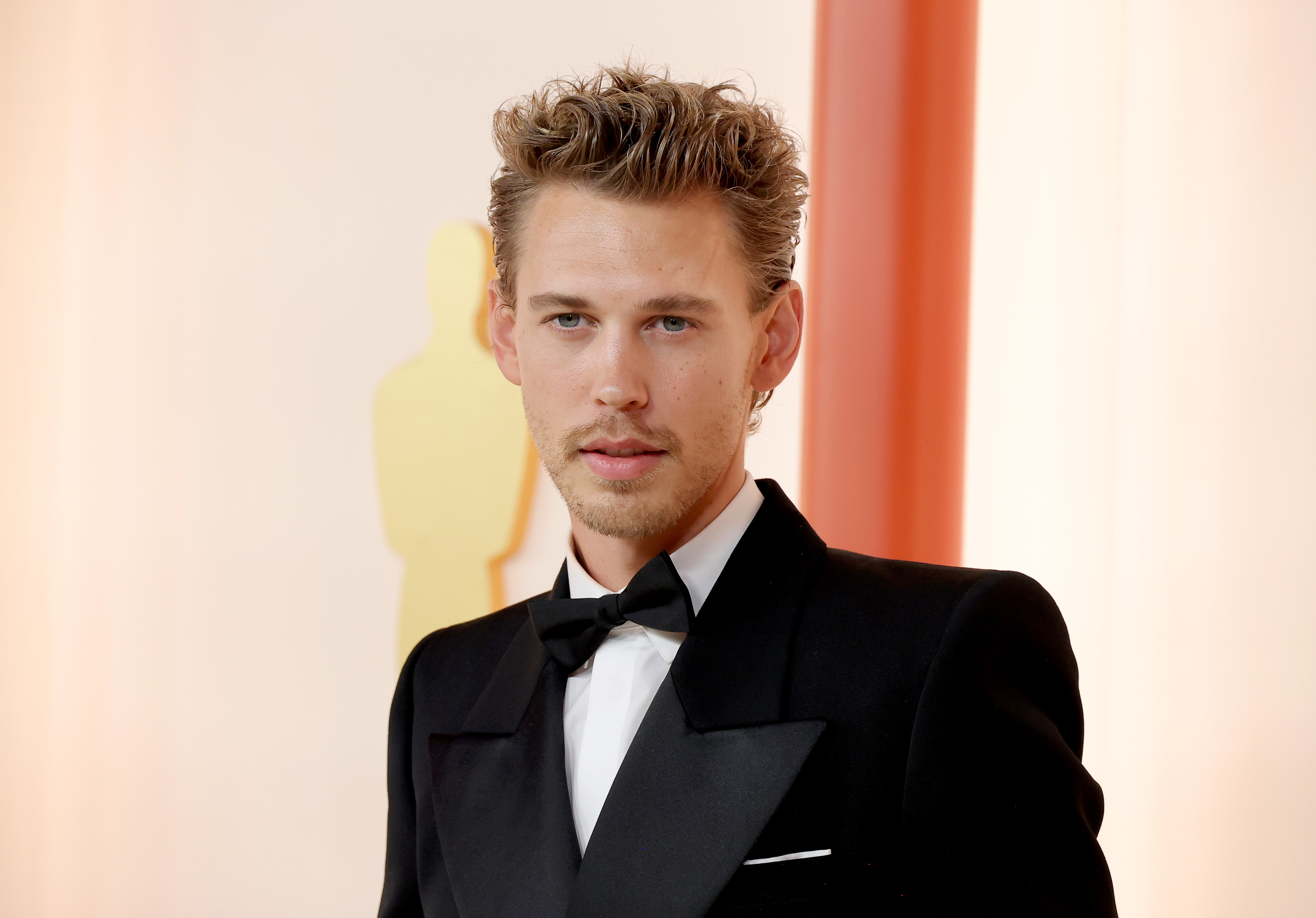 Close-up of Austin in a suit and bow tie at a media event