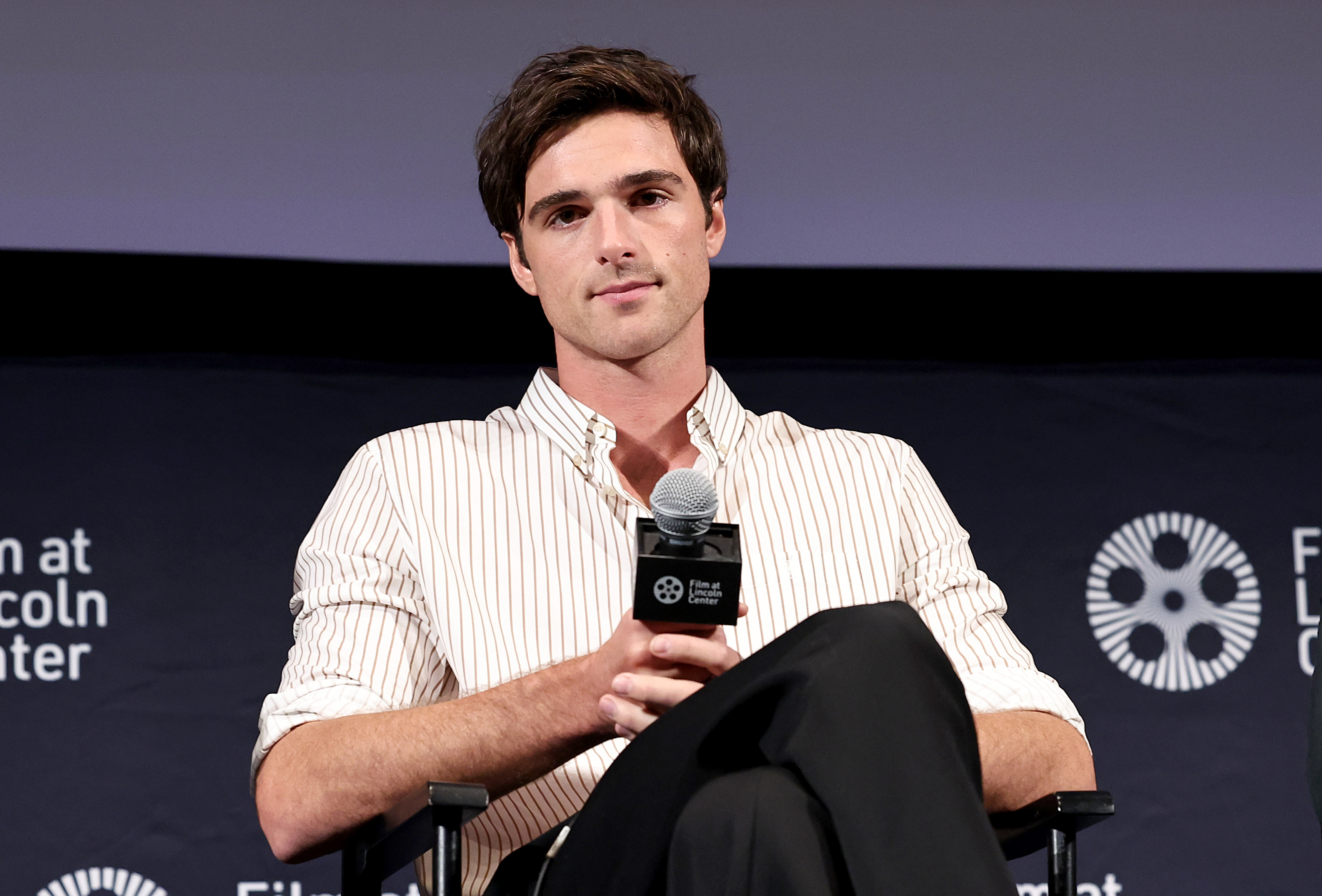 Close-up of Jacob sitting onstage at a media event