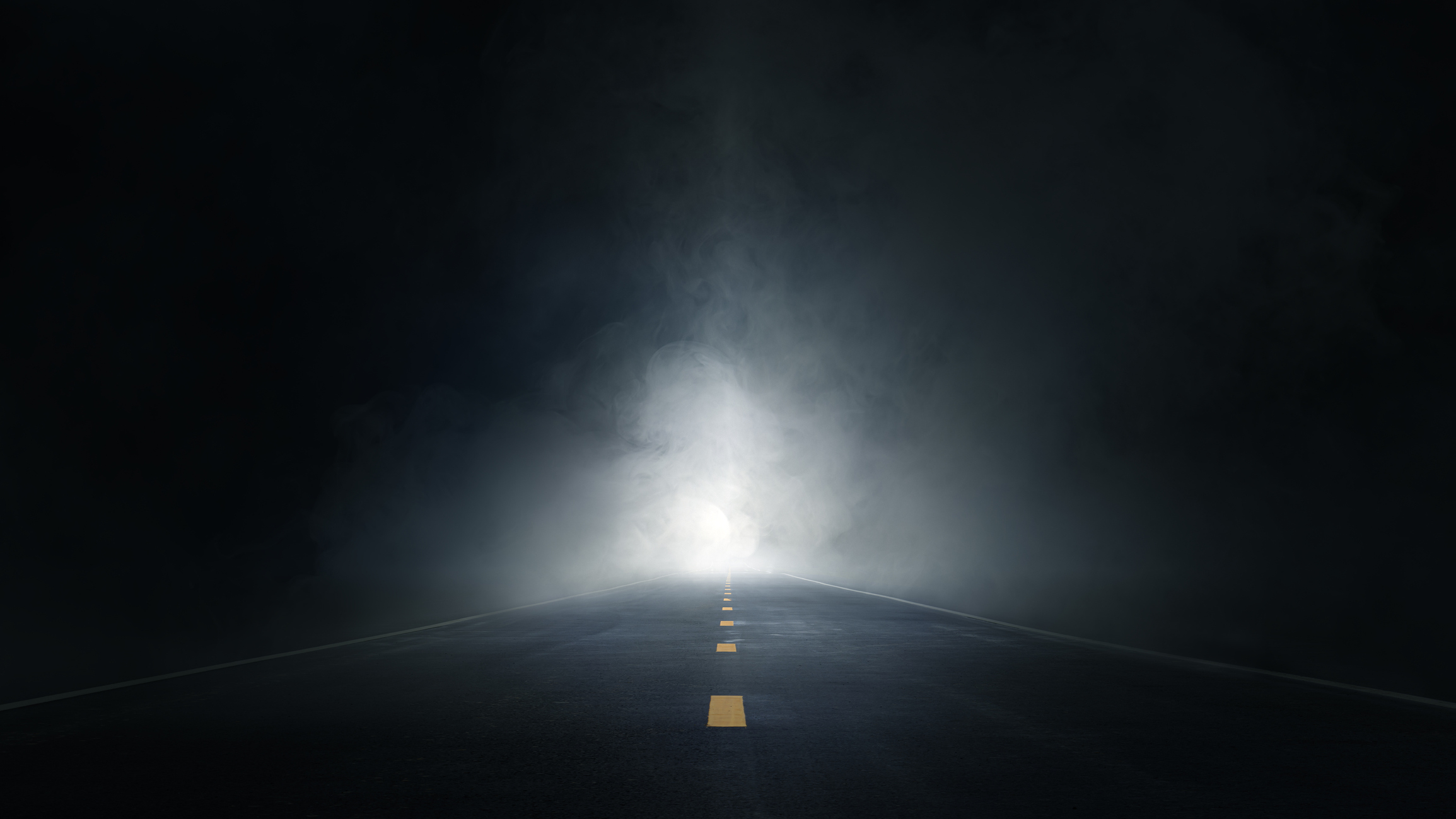 a bright light on a dark road