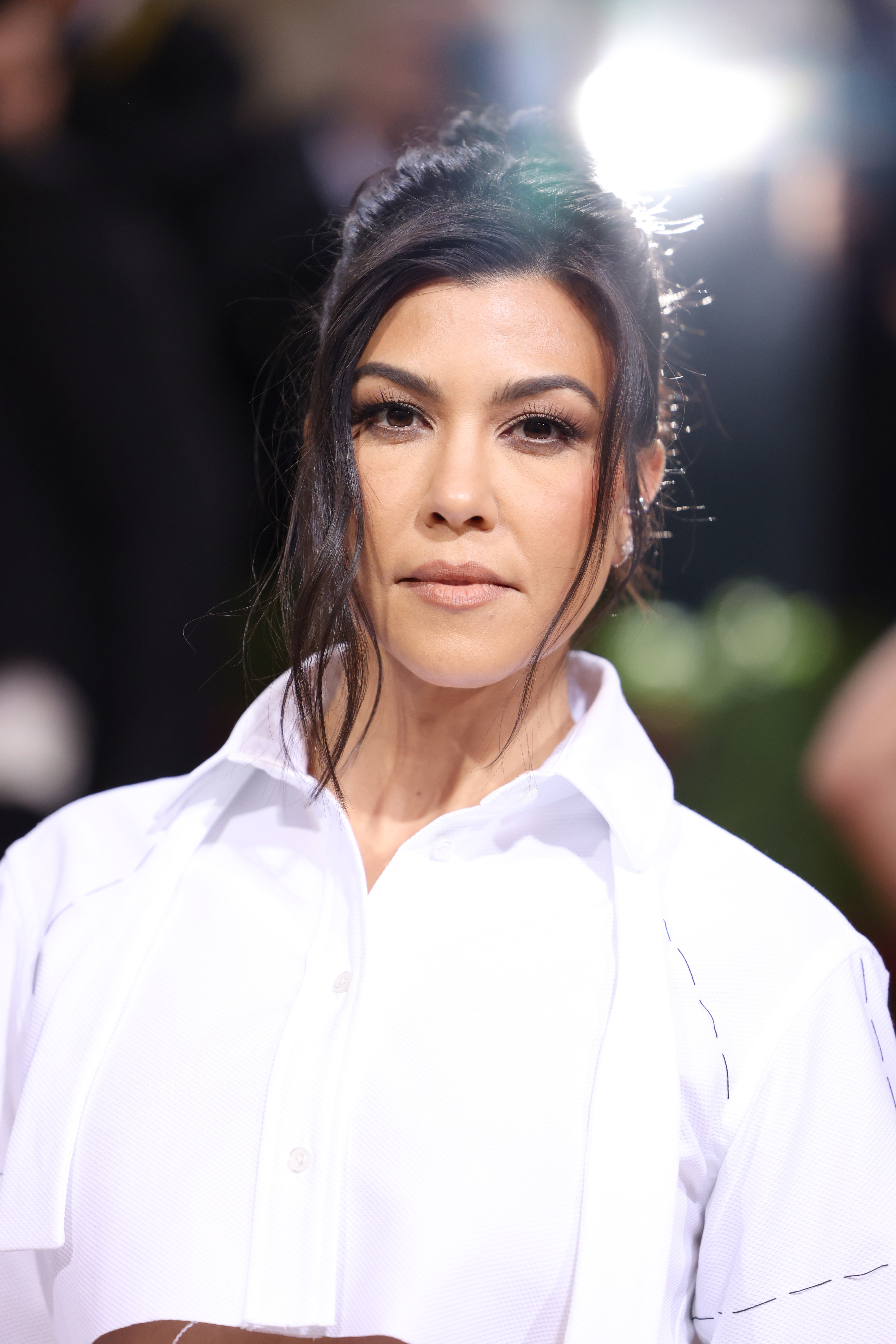 Close-up of Kourtney wearing a blouse