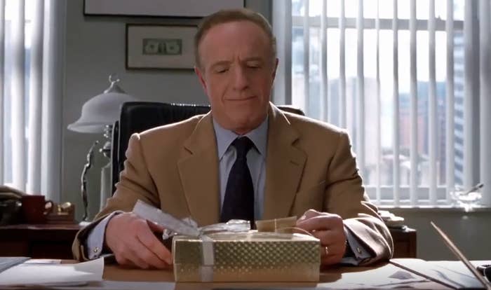James Caan&#x27;s character opening up a tiny gift at his desk in &quot;Elf&quot;