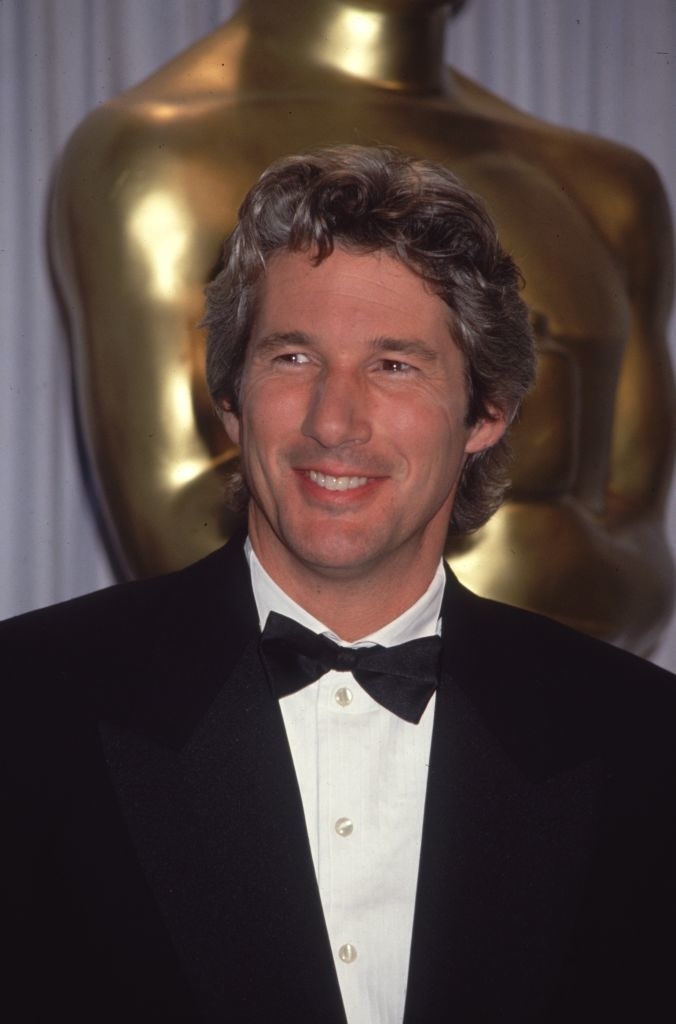 Close-up of Richard smiling in a suit and bow tie at a media event