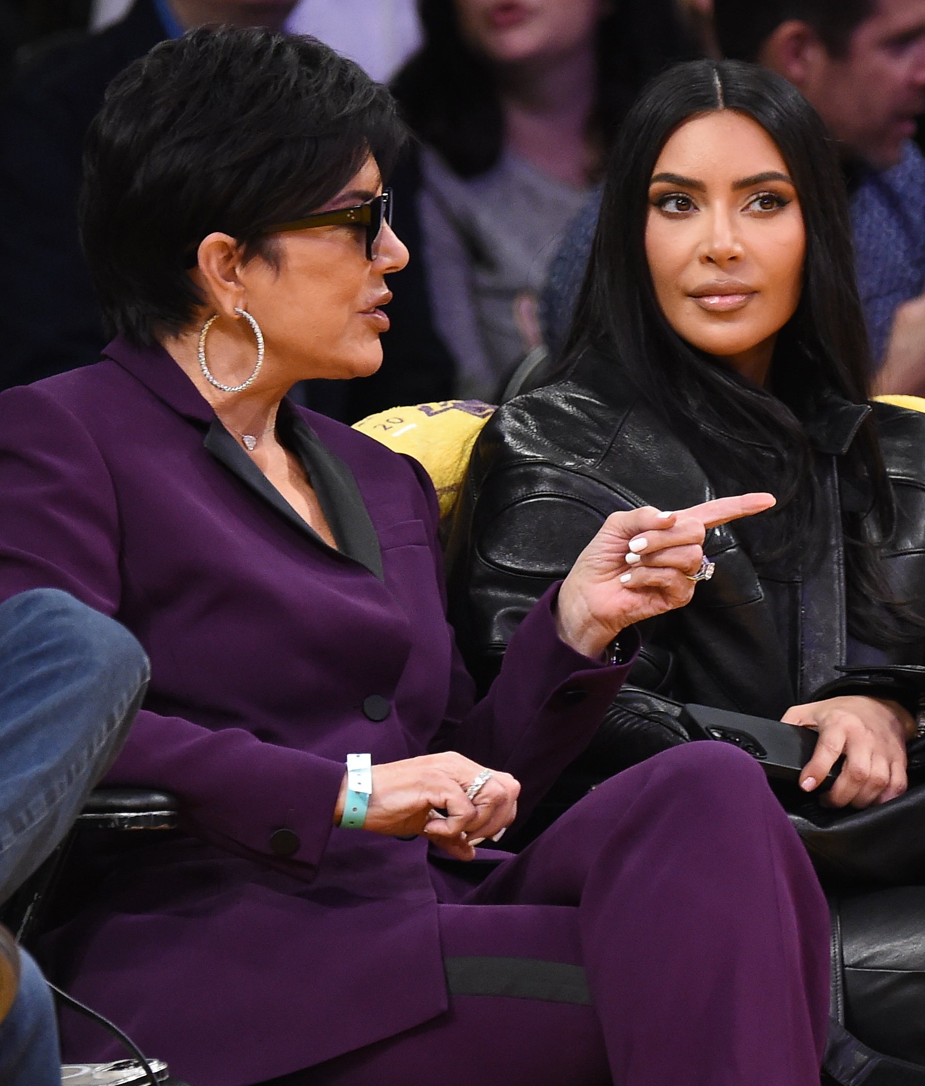 Close-up of Kim and Kris sitting together in an audience