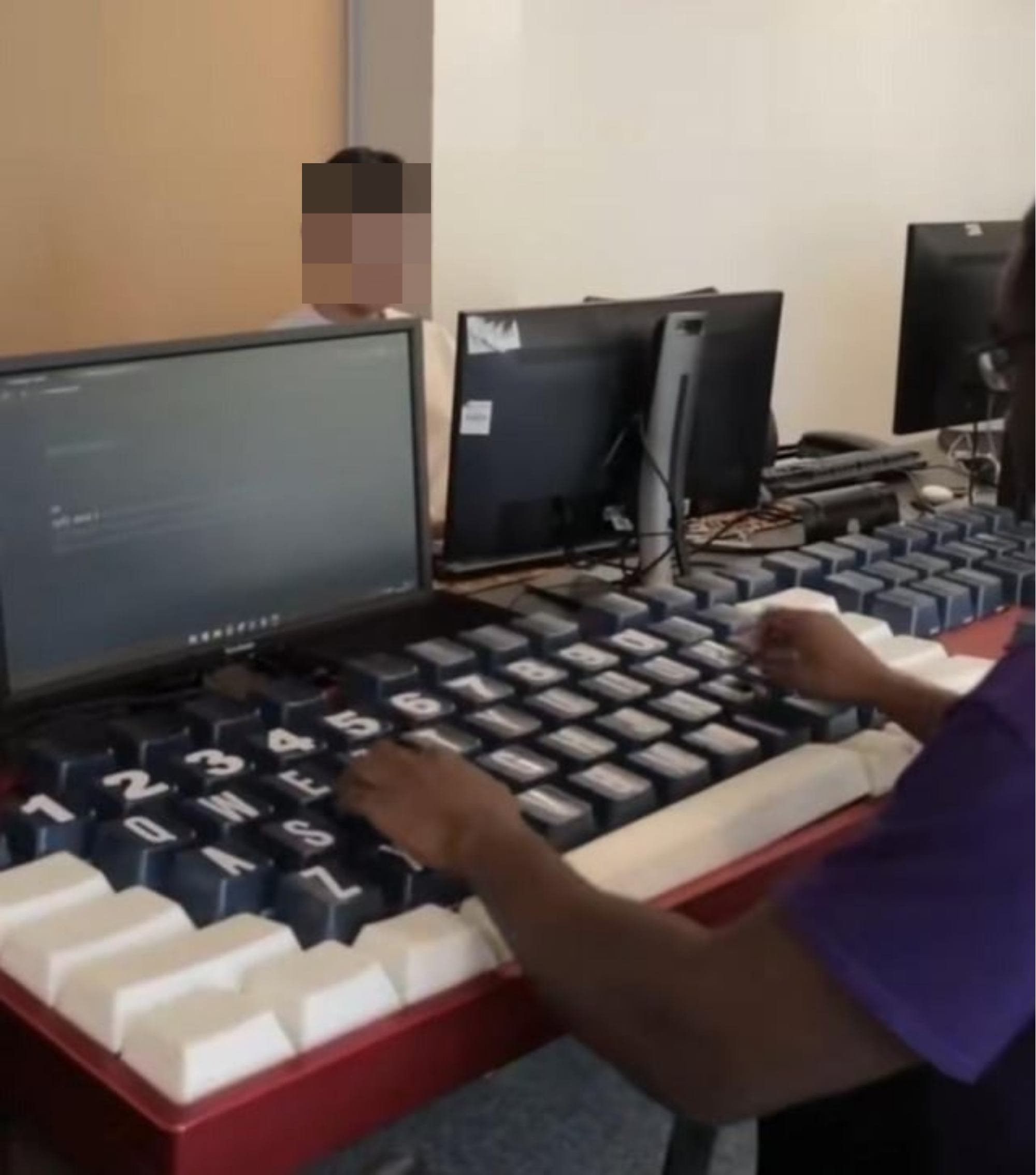 A person using a giant keyboard