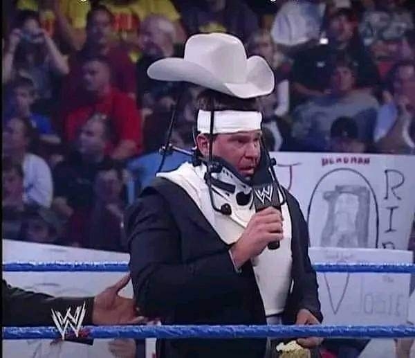 Vince McMahon wearing a neck brace with a cowboy hat