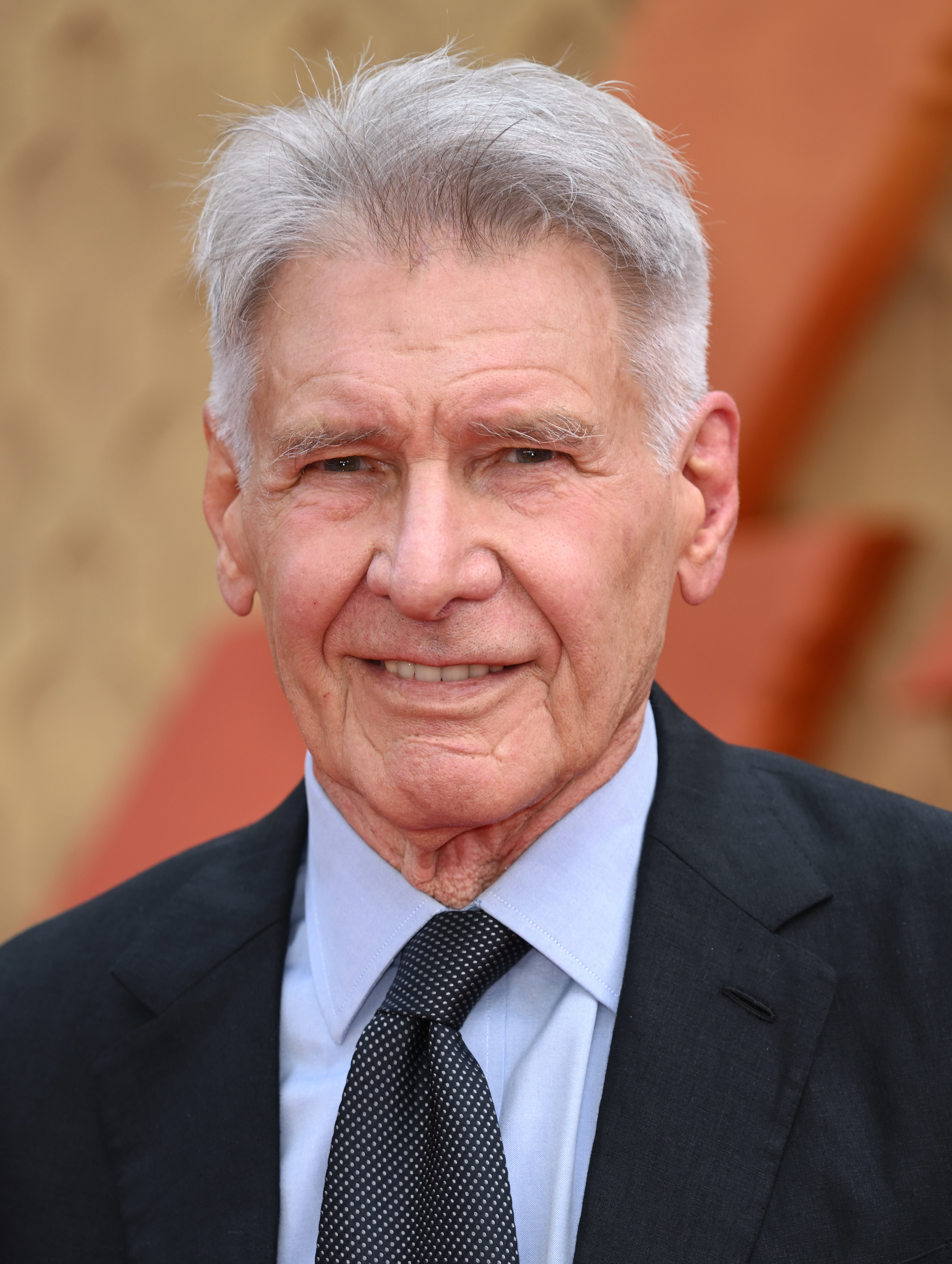 Close-up of Harrison in a suit and tie