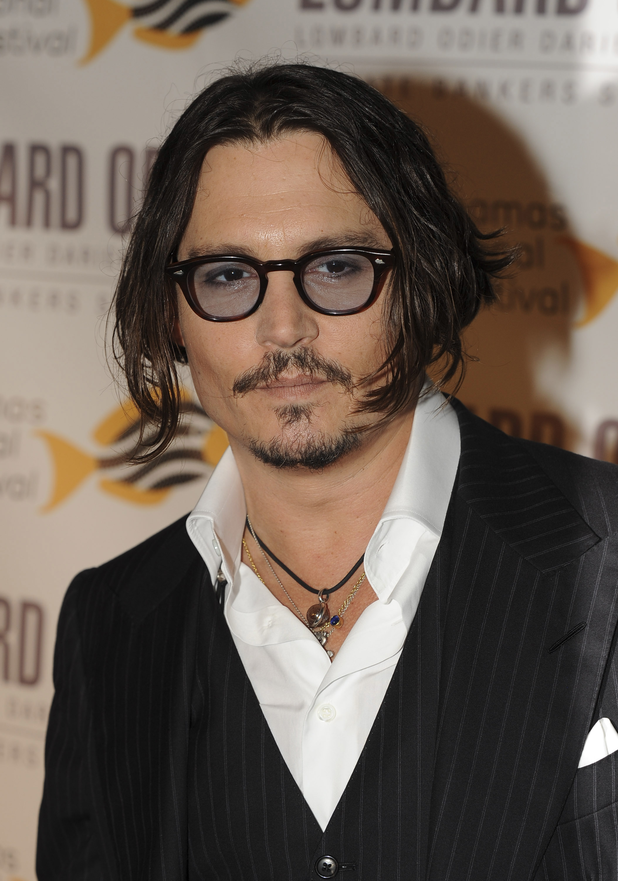 Close-up of Johnny in a suit at a media event