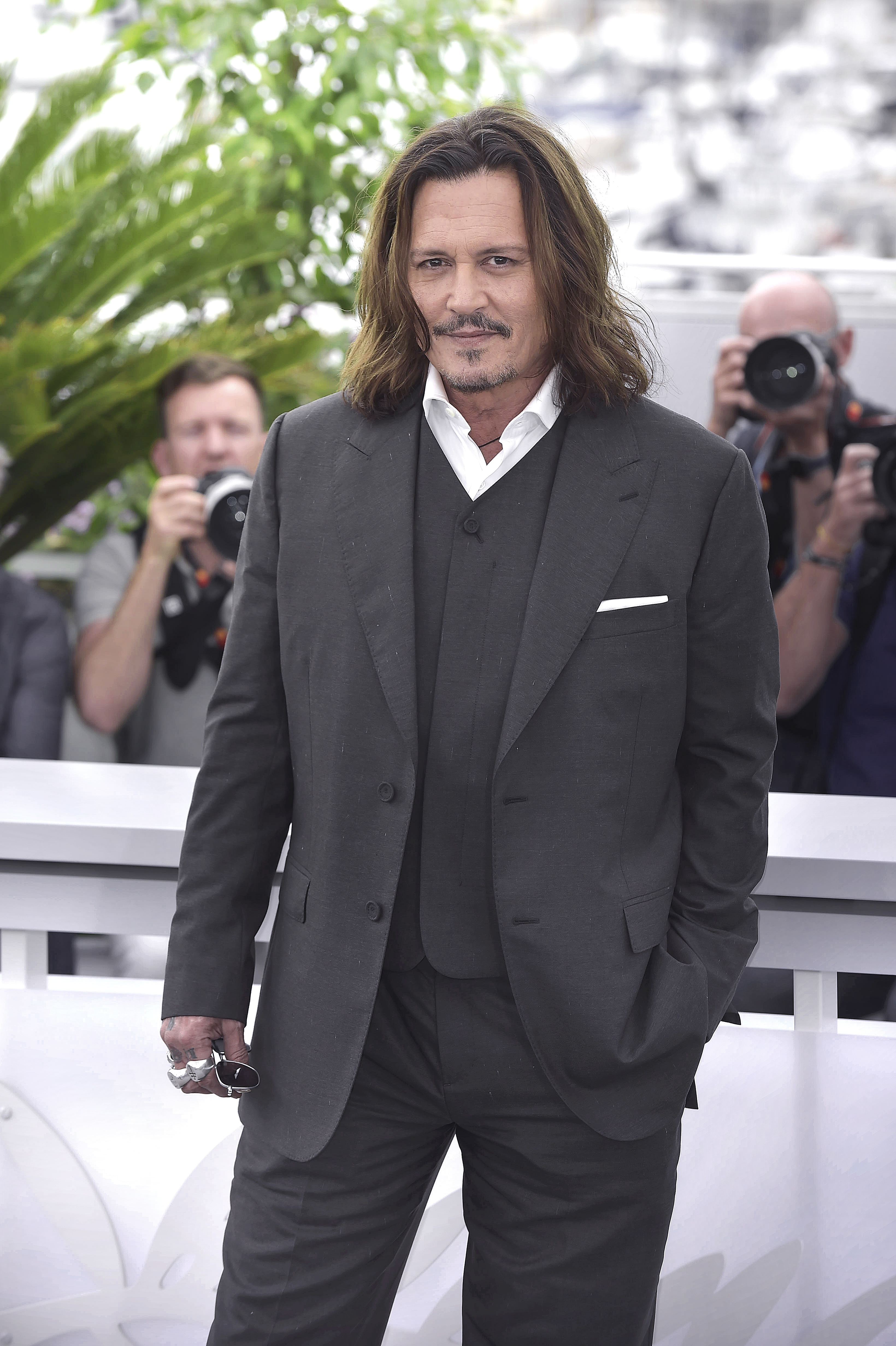 Close-up of Johnny in a three-piece suit at a media event