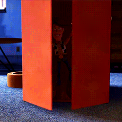 Gif of Woody from &quot;Toy Story 4&quot; coming out of a box cockily with his arms spread