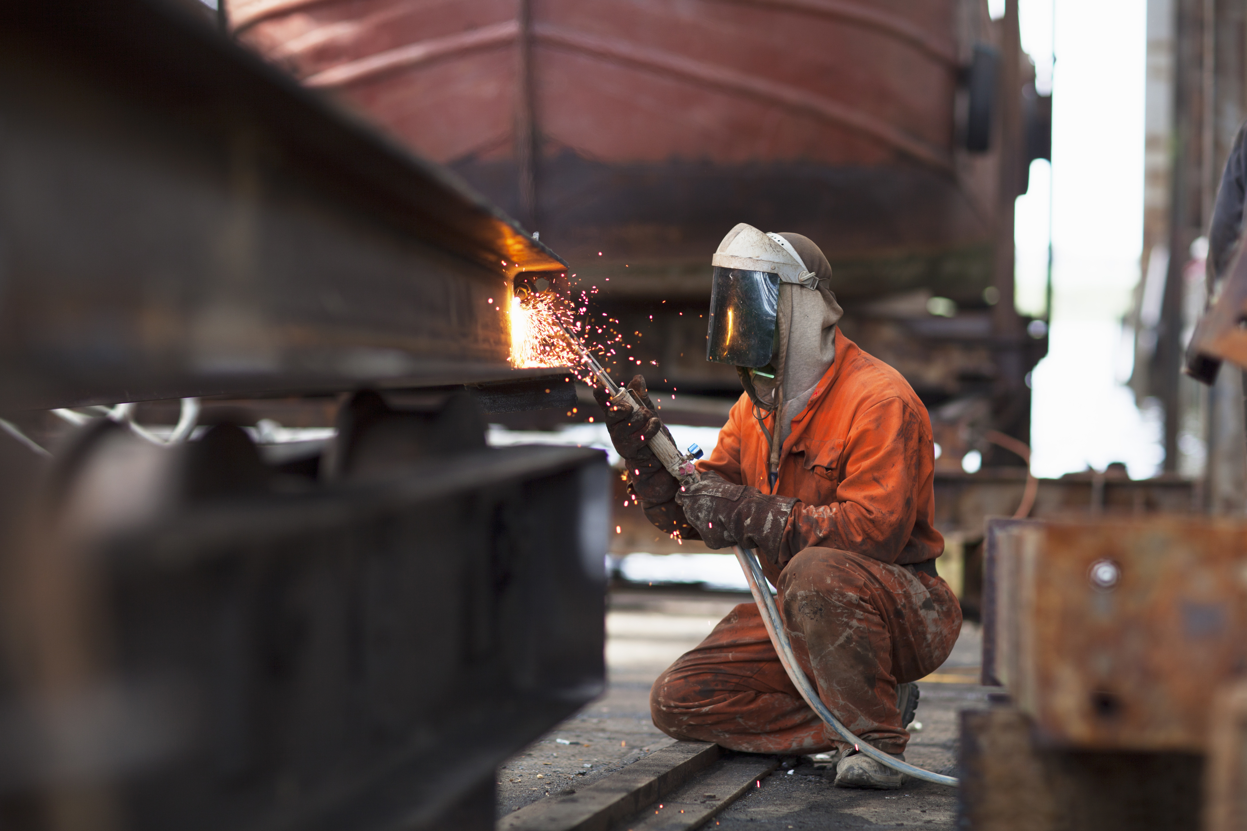 welder working on a project wearing a mask over their face for protection