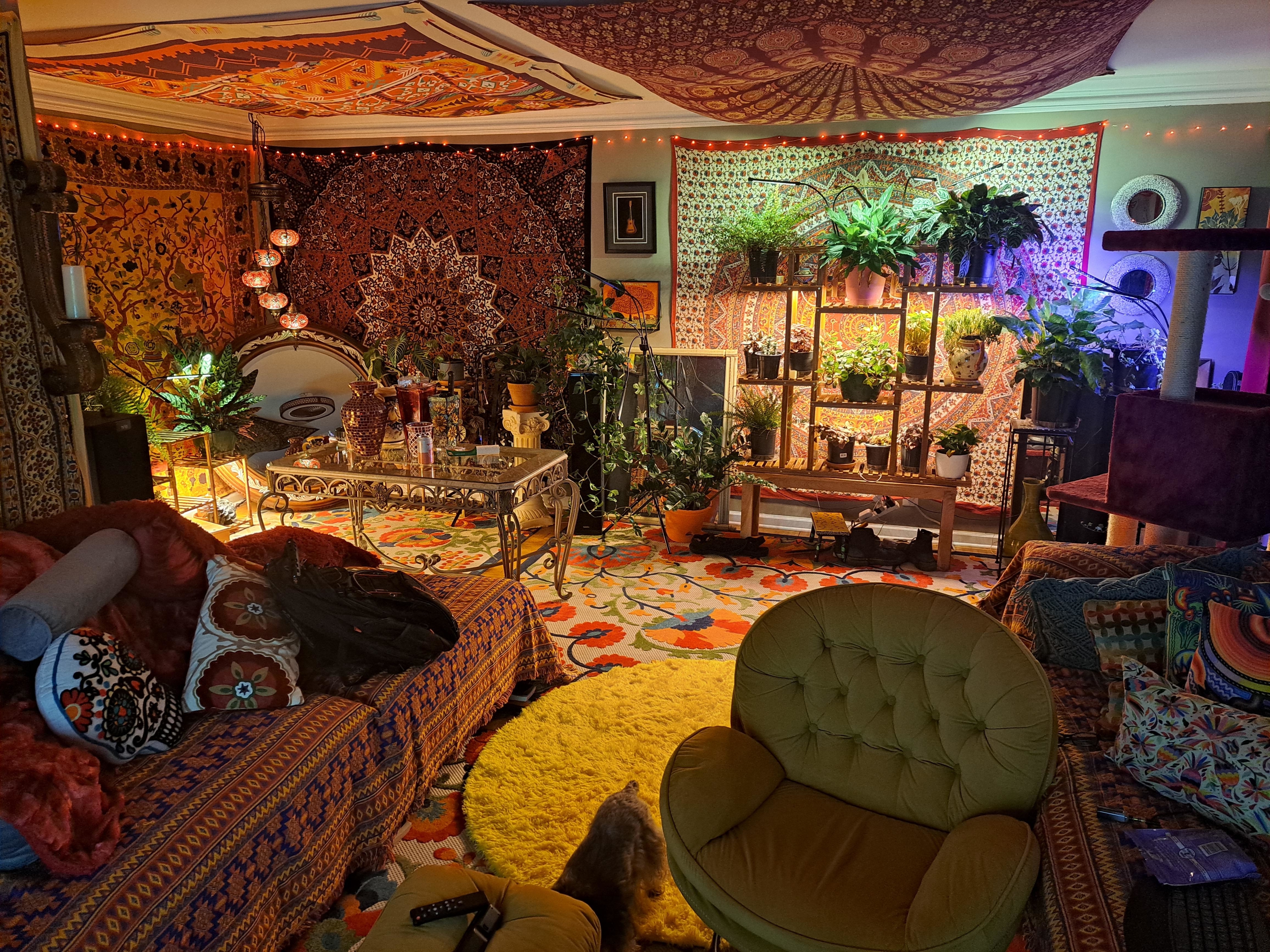 A living room with tapestries lining the walls and ceiling