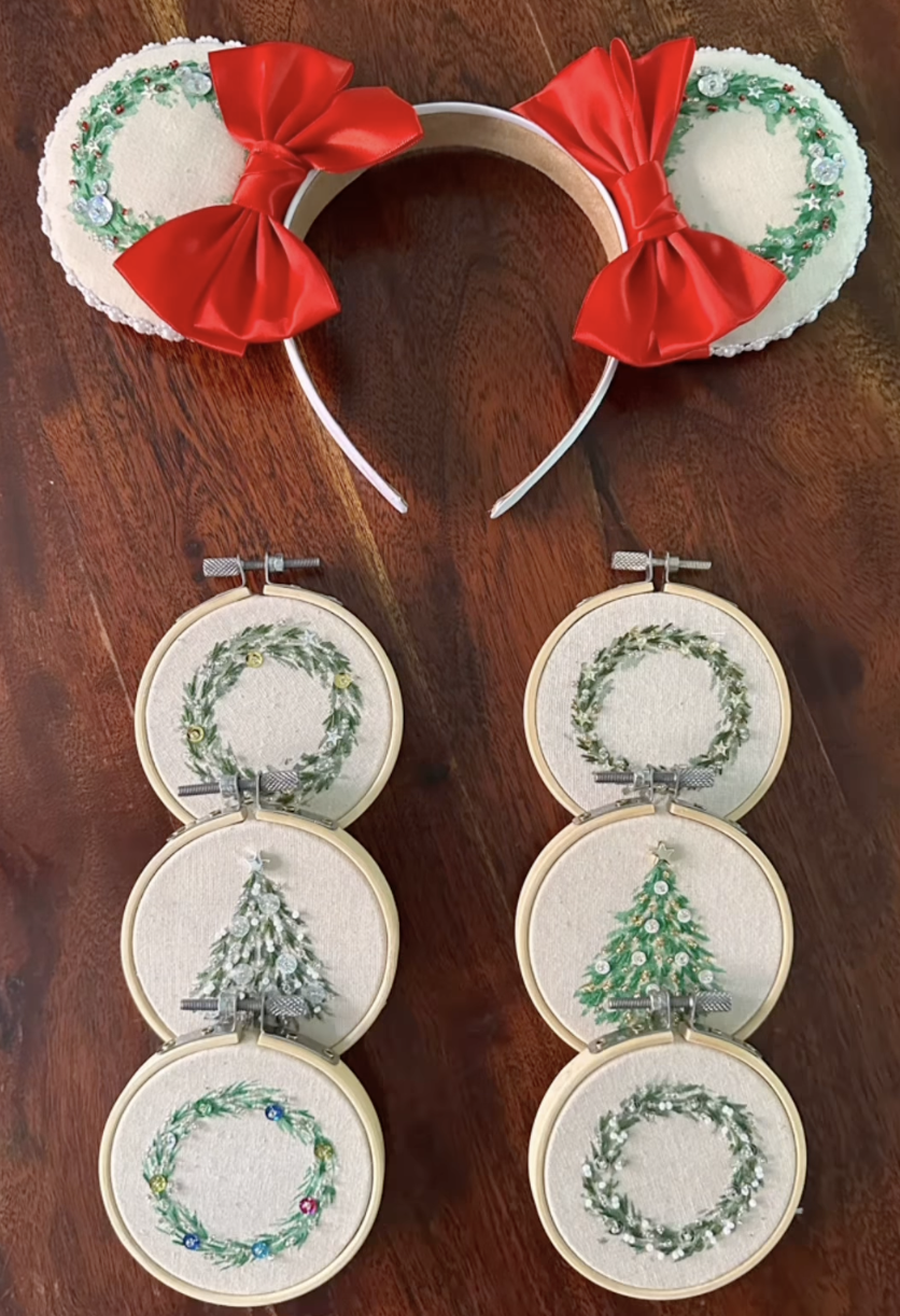 A collection of circular embroidery art pieces with stitched-on wreaths and Christmas trees.