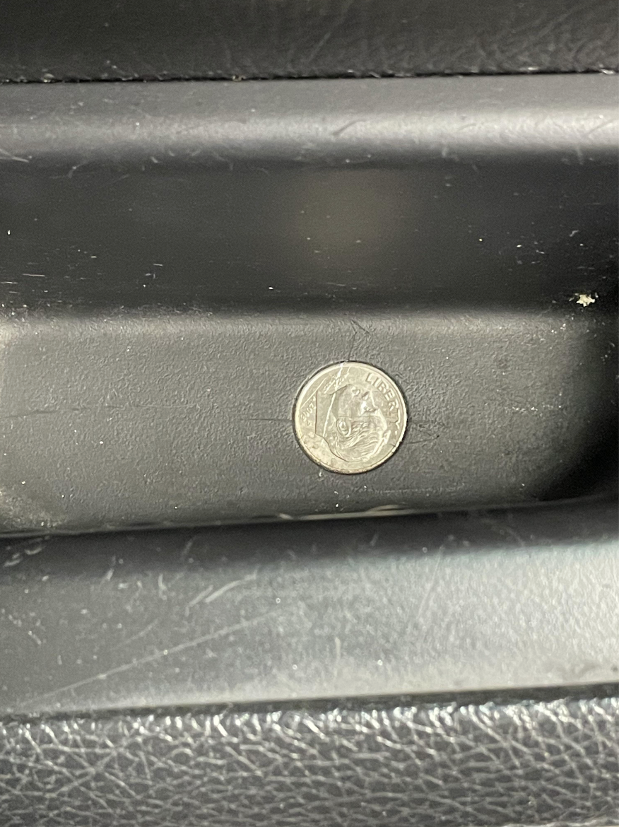 dime inside a hole in the car