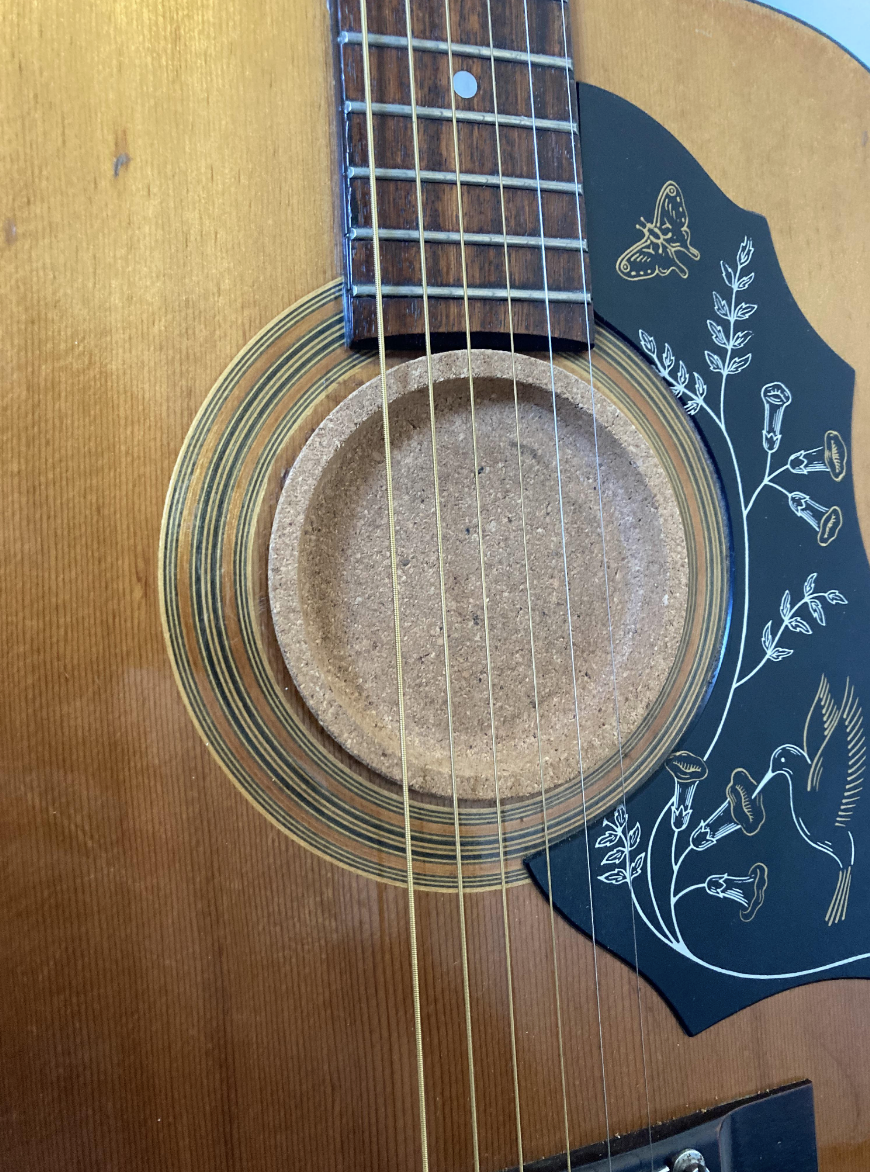 coaster covers the hole in the guitar