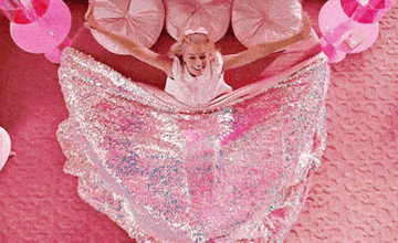 barbie waking up in a glittery pink bed