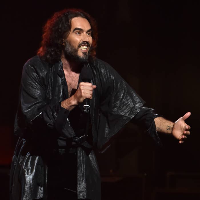 Lester Cohen / Getty Images for The Recording Academy LOS ANGELES, CALIFORNIA - JANUARY 24: (EDITORS NOTE: Retransmission with alternate crop.) Russell Brand speaks onstage during MusiCares Person of the Year honoring Aerosmith at West Hall at Los Angeles Convention Center on January 24, 2020 in Los Angeles, California. (Photo by Lester Cohen/Getty Images for The Recording Academy )