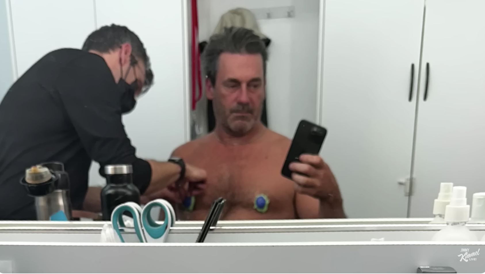 Jon taking a selfie while getting his nipples put on