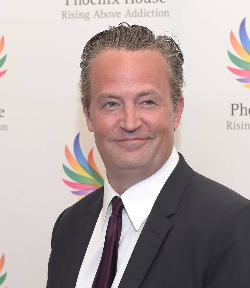 Close-up of Matthew in a suit and tie at a media event