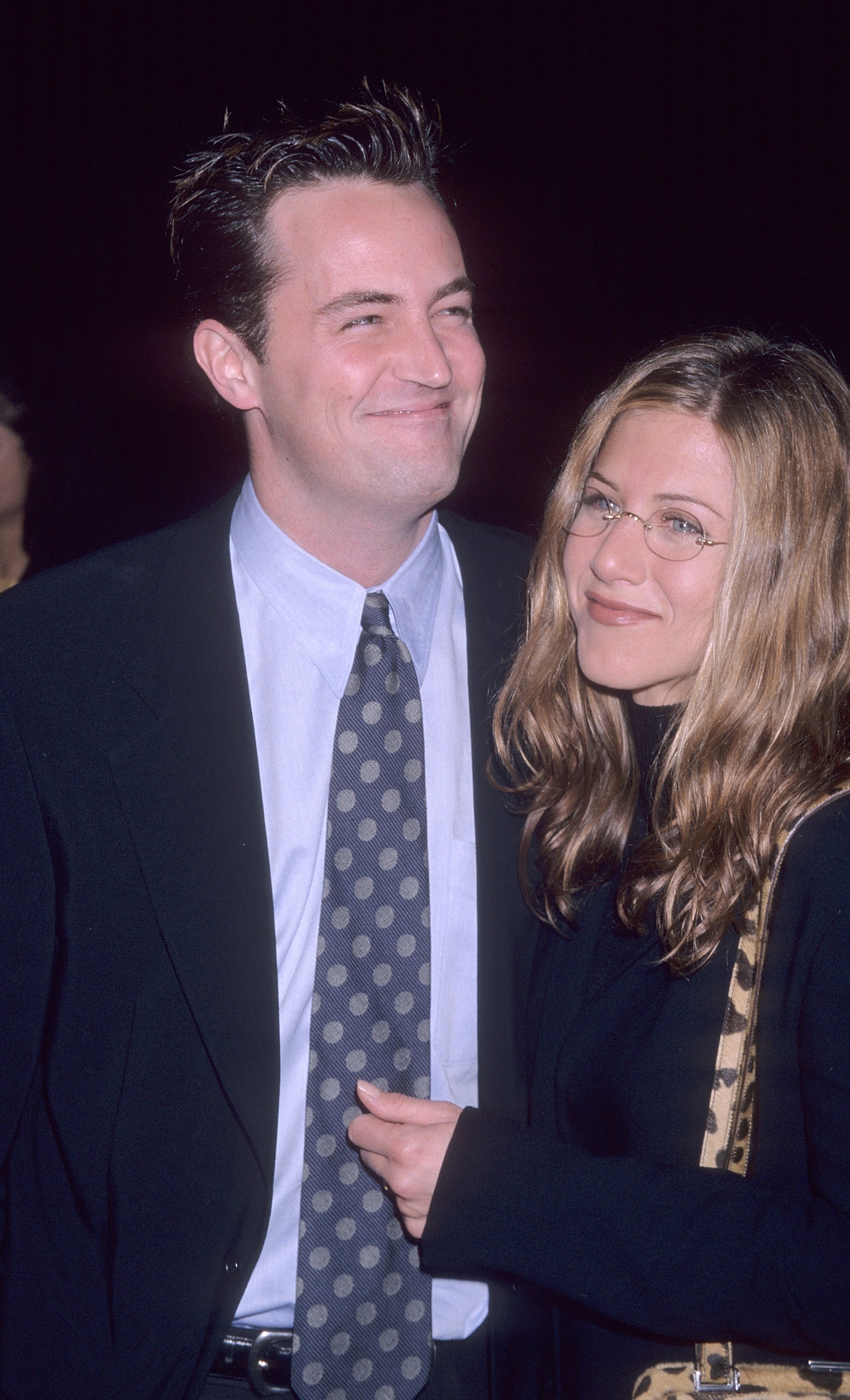 Close-up of a smiling Matthew  in a suit and tie with Jennifer