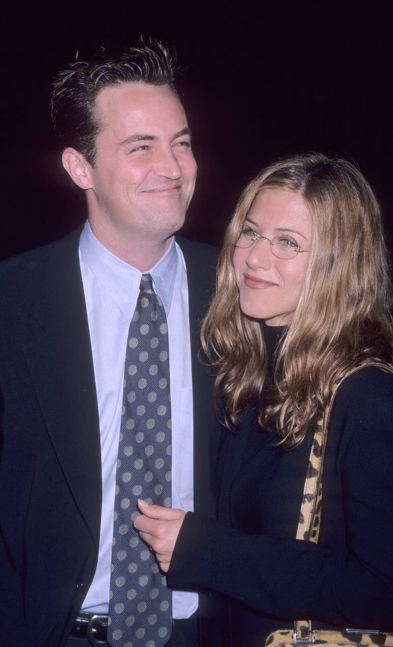 Close-up of a smiling Matthew in a suit and tie with Jennifer