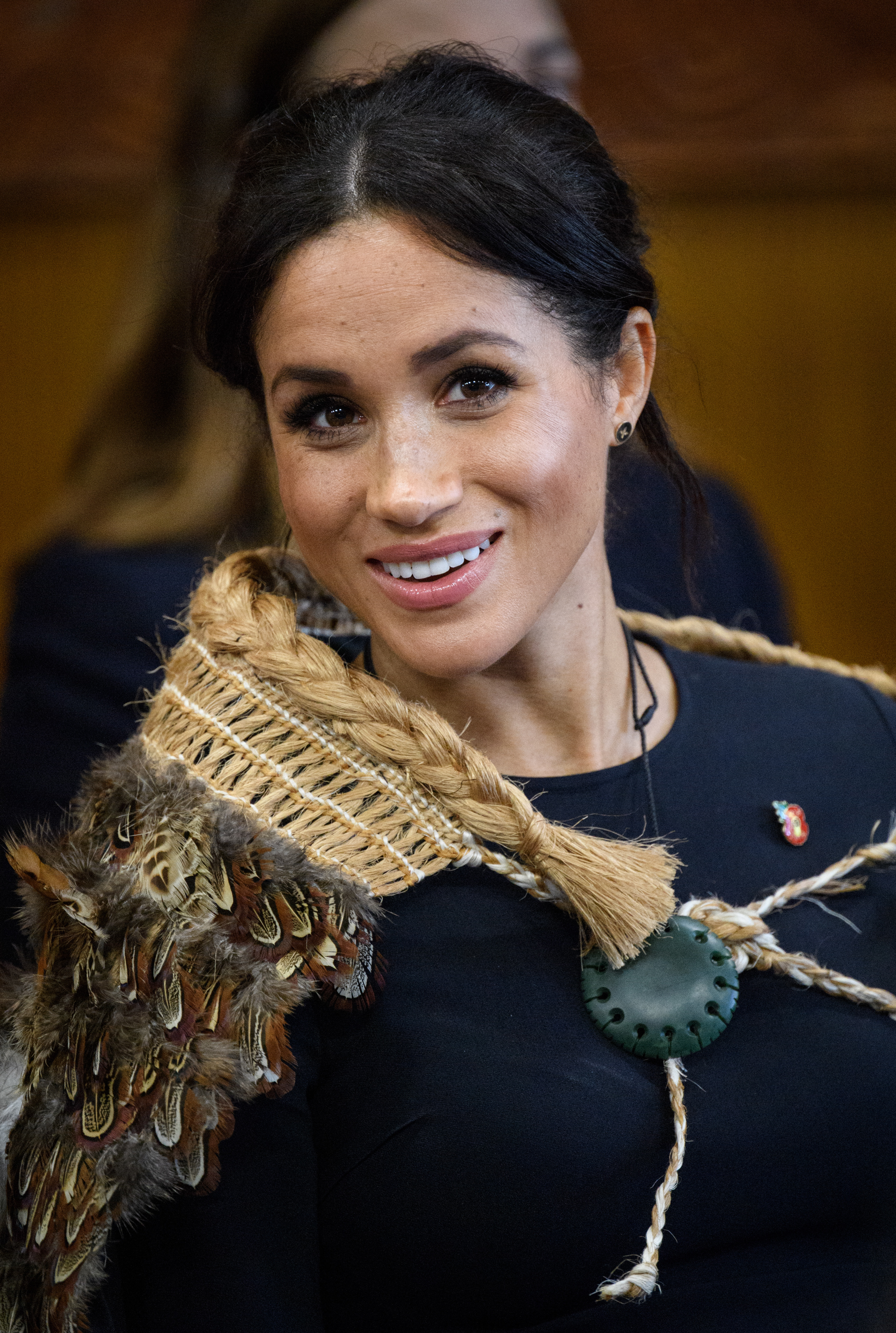 Close-up of Meghan smiling and wearing a feathery shawl