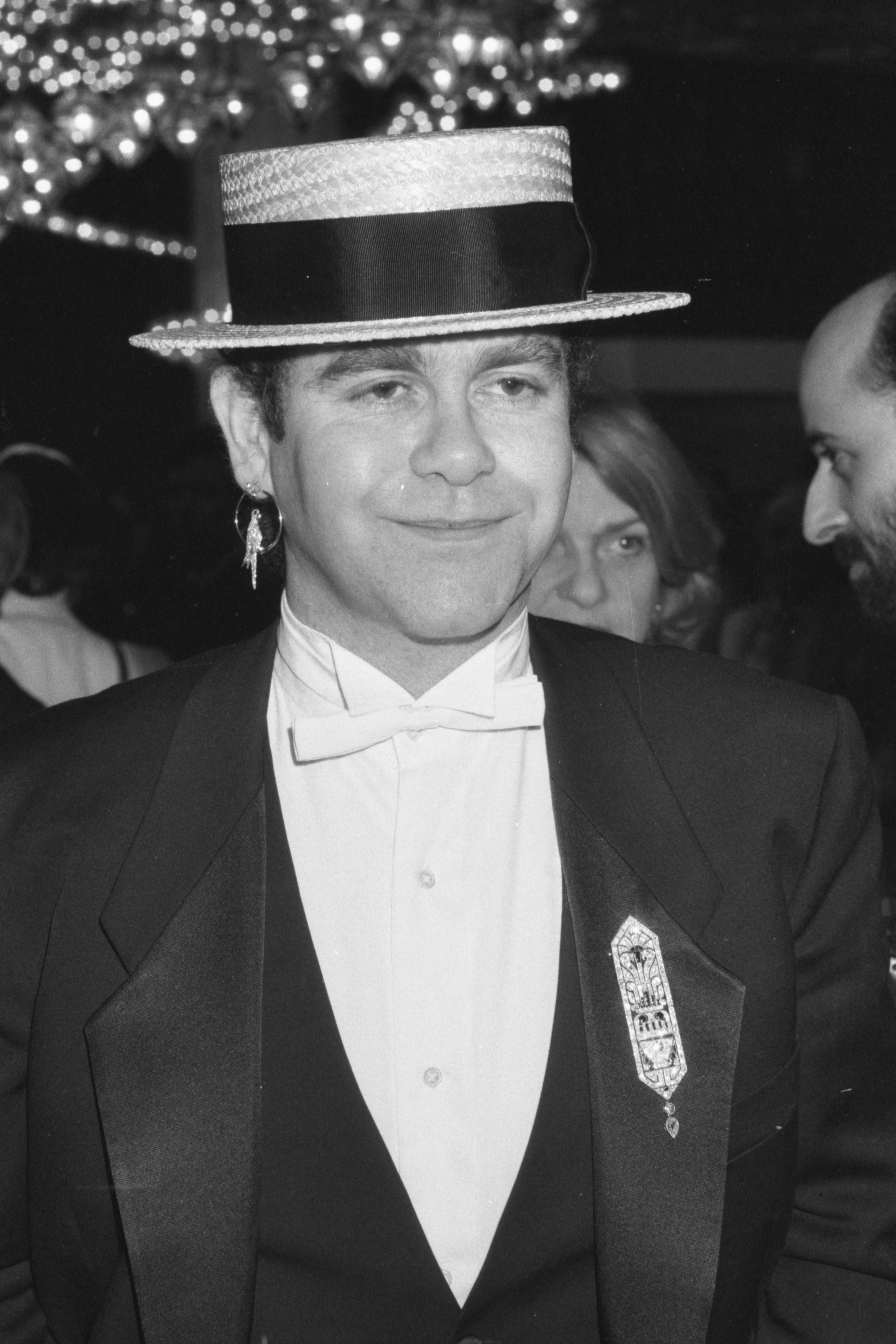 Elton in a suit and bow tie and top hat