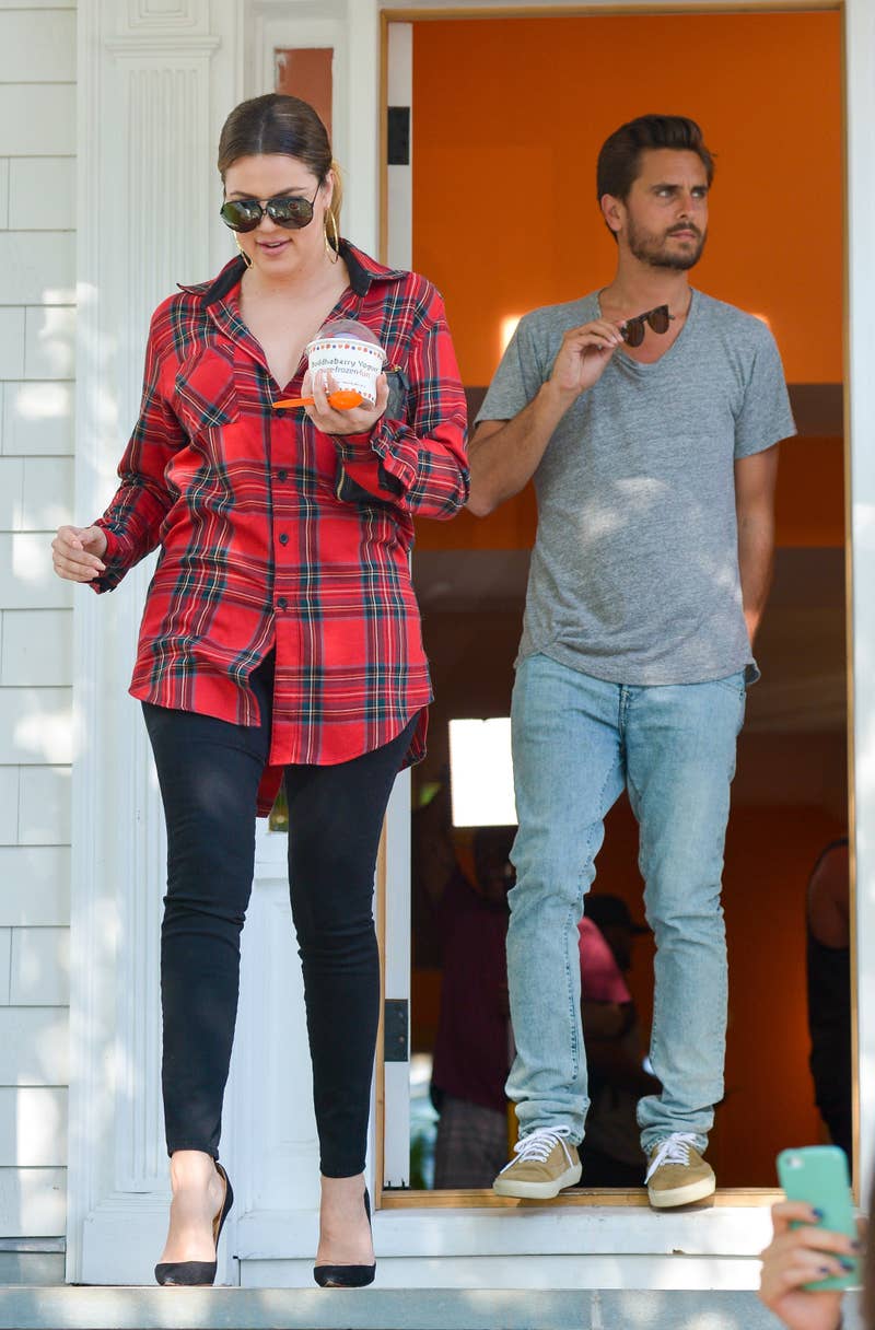 Close-up of Khloé and Scott standing together by a doorway