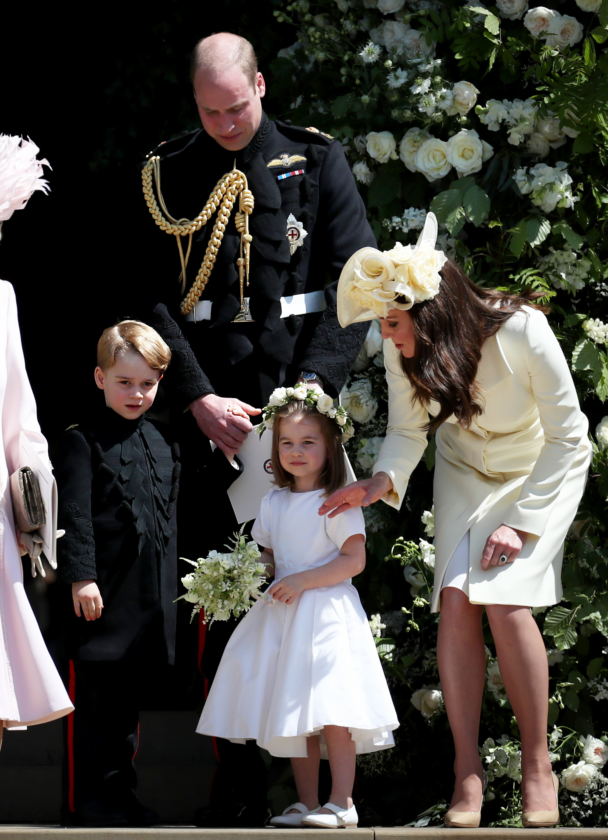 Kate in a suit and hat with Prince William and two of their children