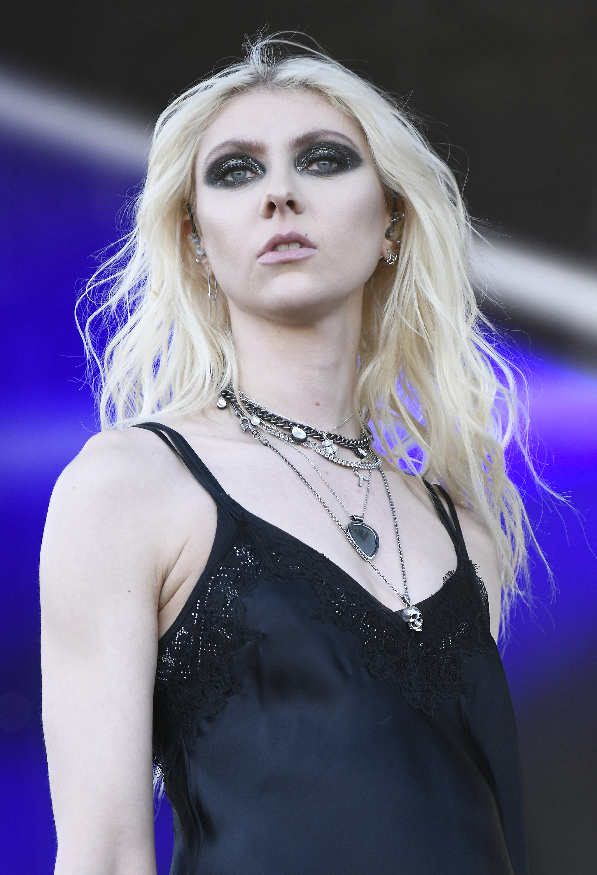 closeup of her with dark eye makeup and jewelry on stage