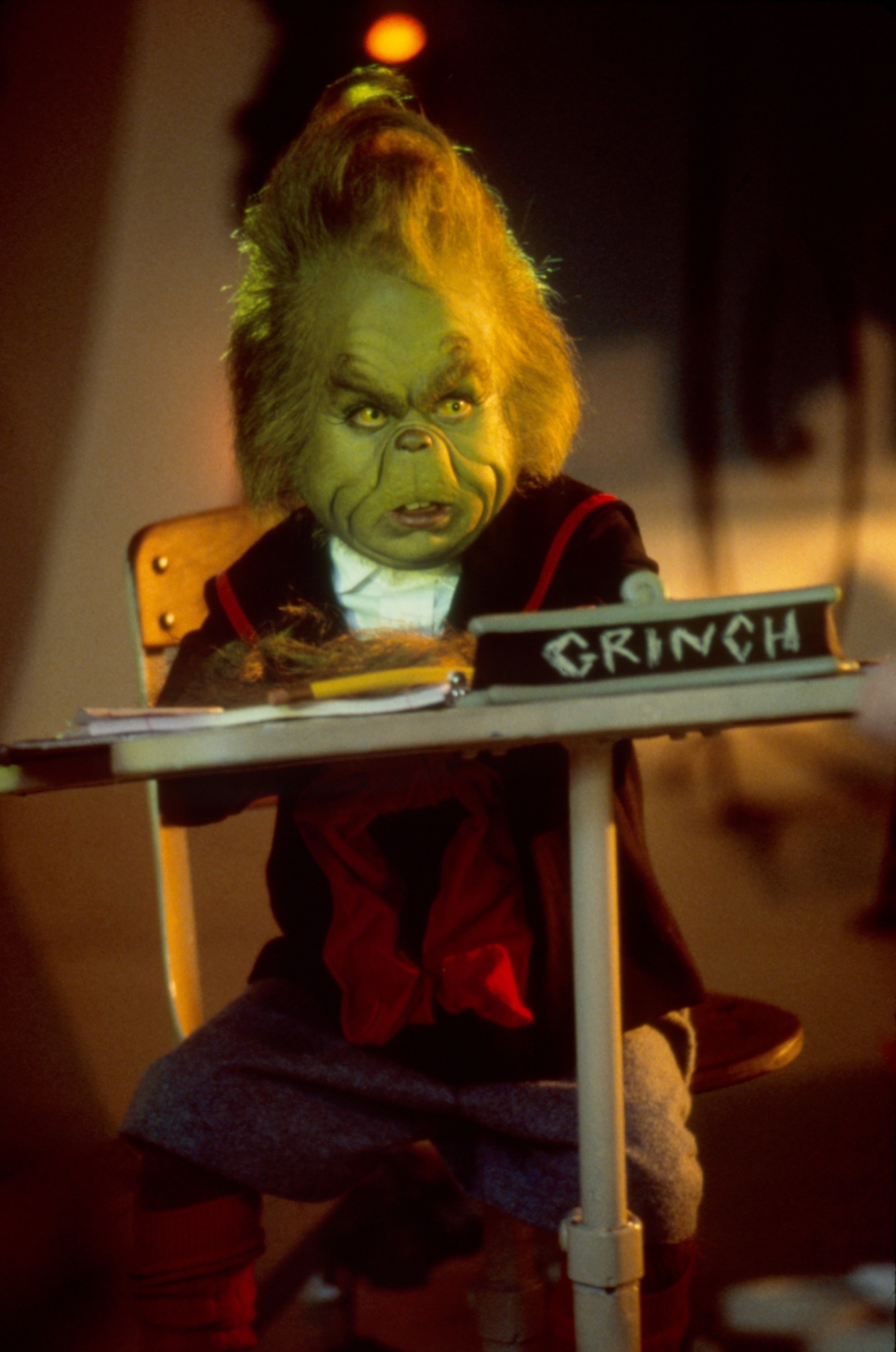 grinch at a student desk