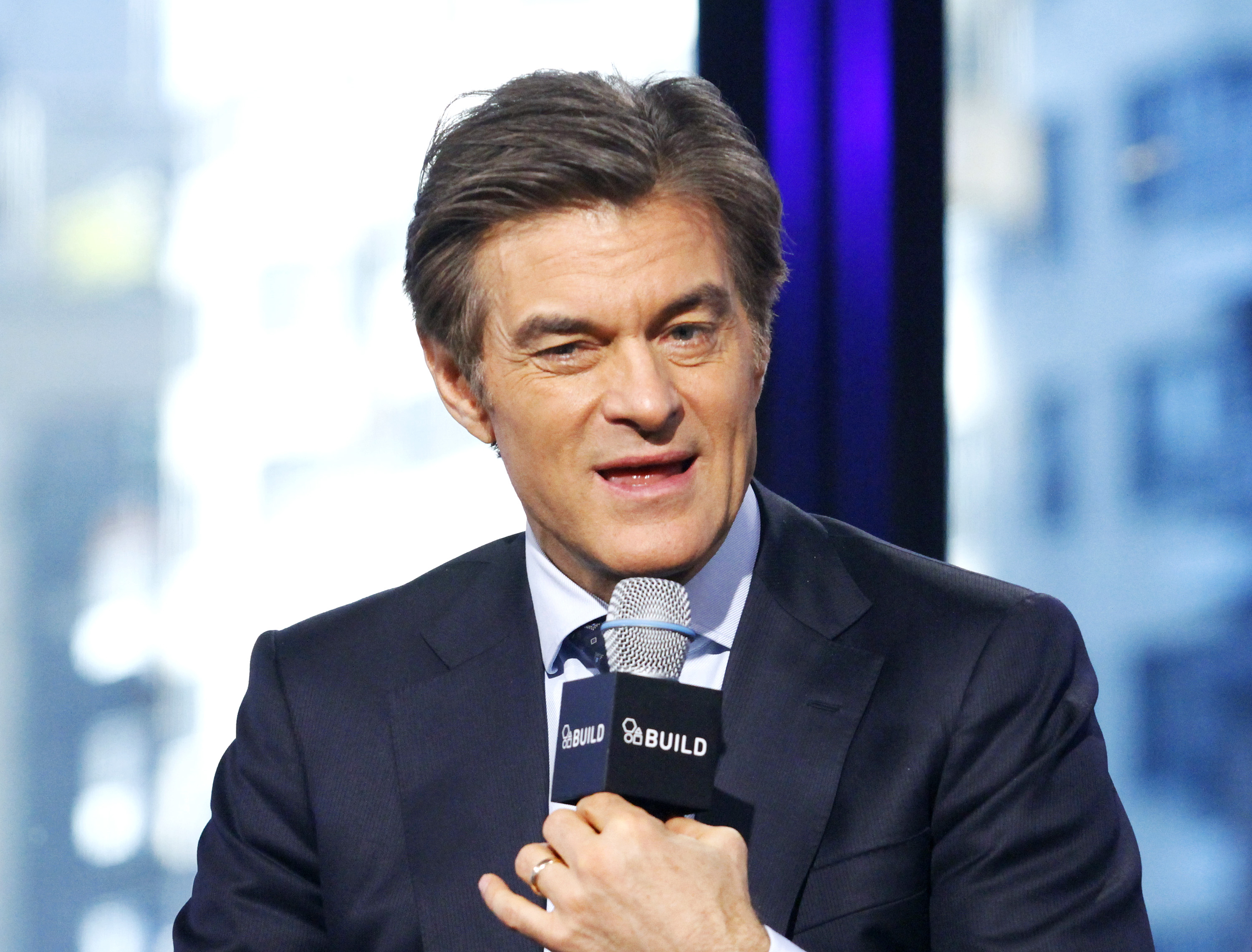 Dr Oz talking on a microphone