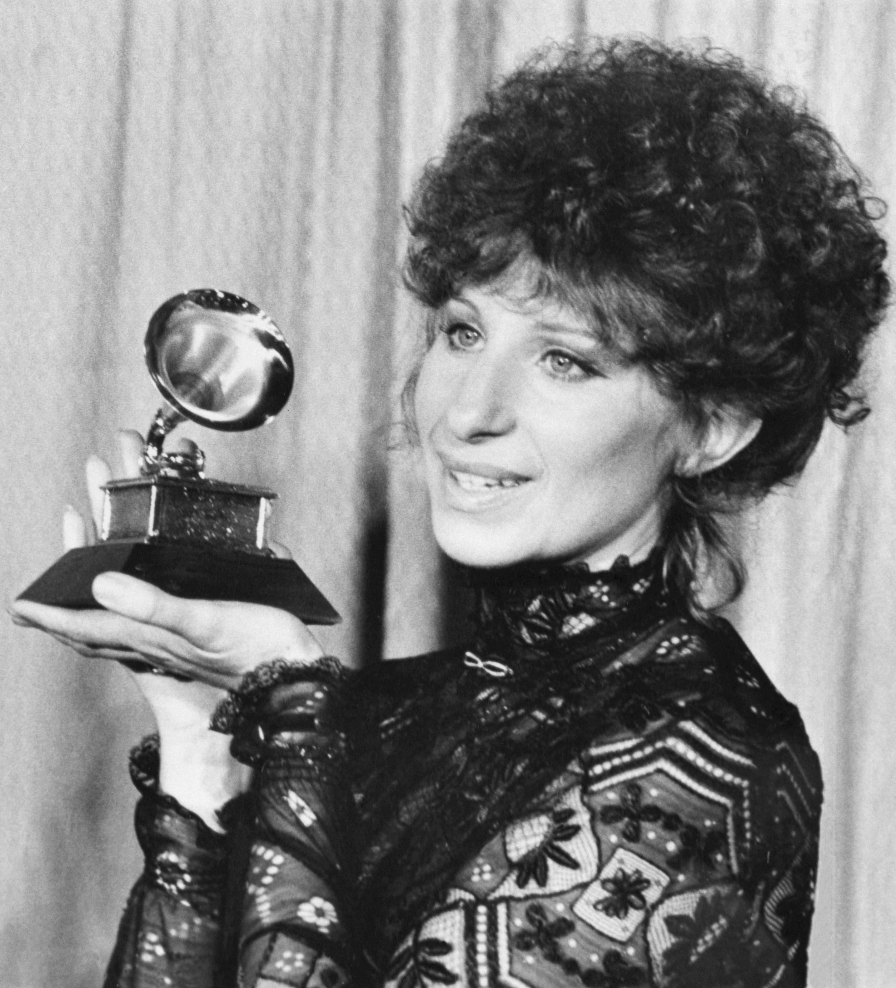 Barbra holding a Grammy