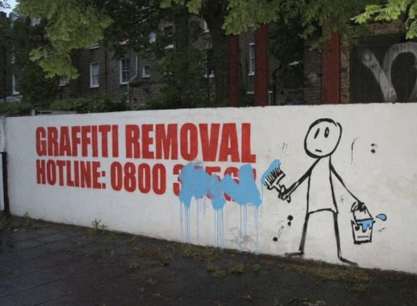 graffiti over a phone number for graffiti removal