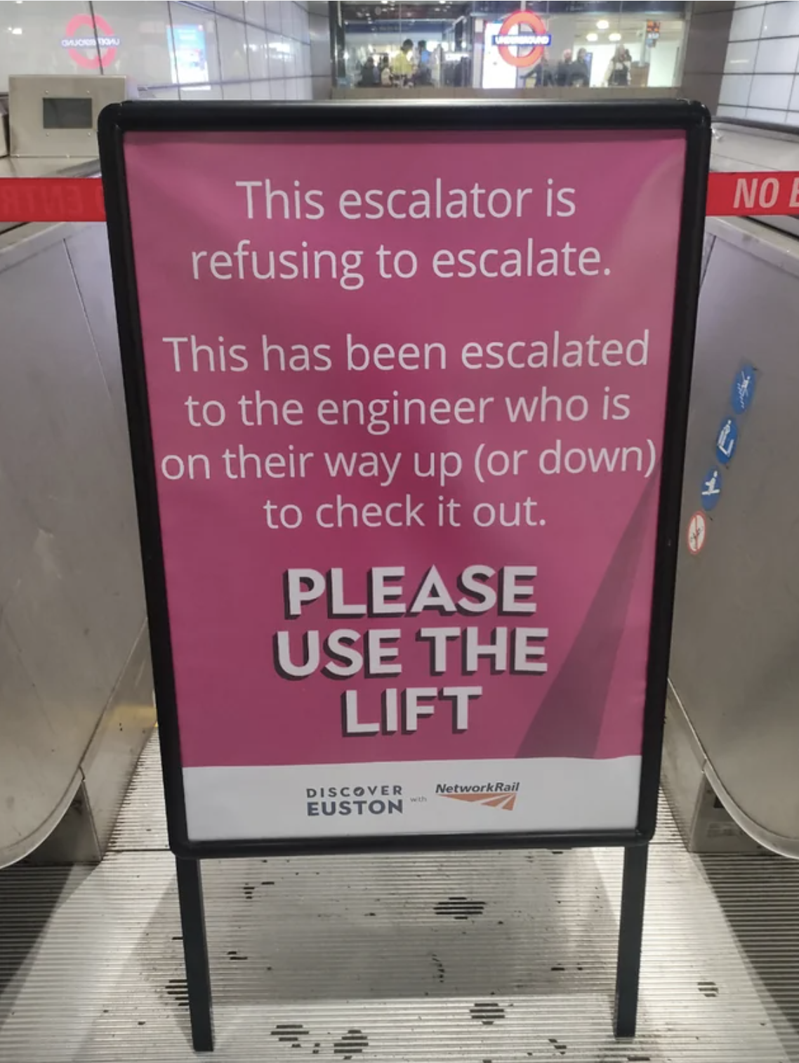 sign in front of the broken escalator