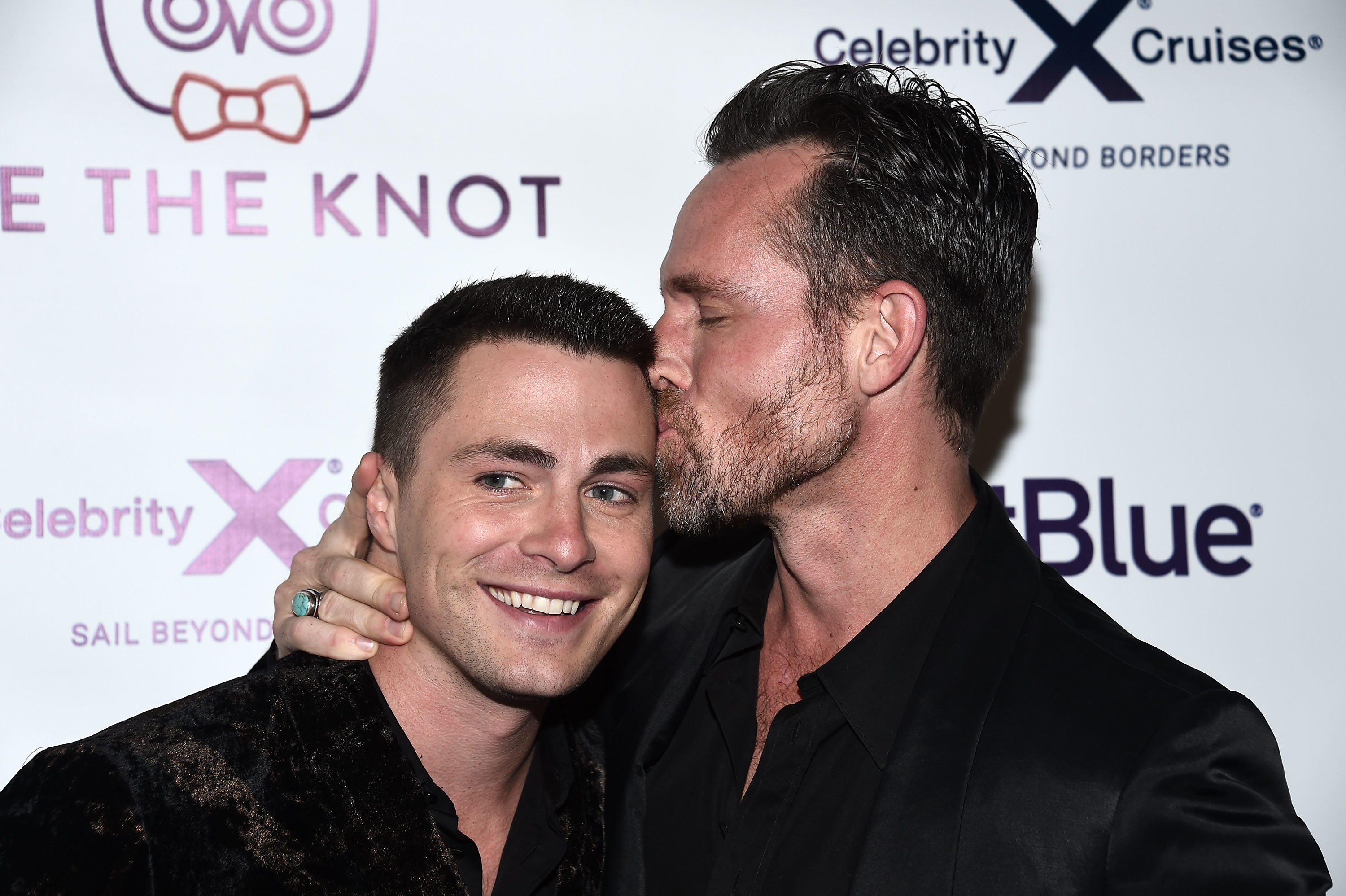 Close-up of Jeff kissing a smiling Colton at a media event