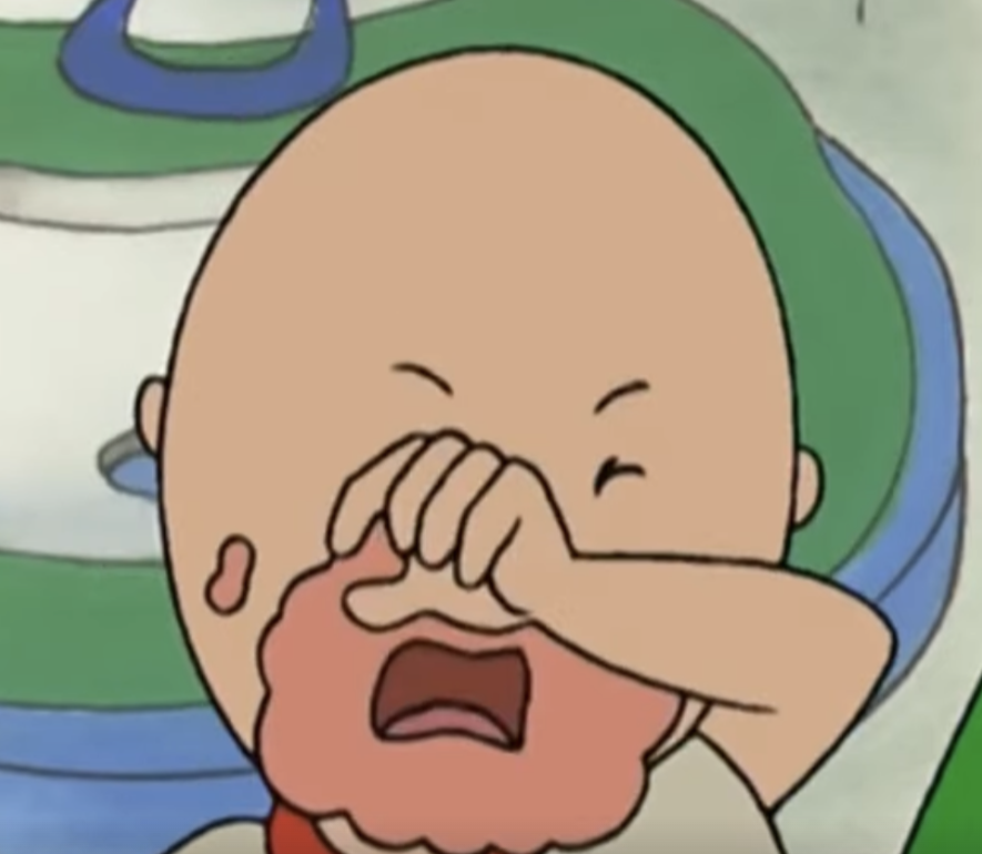 Caillou wipes his mouth of food and cries.