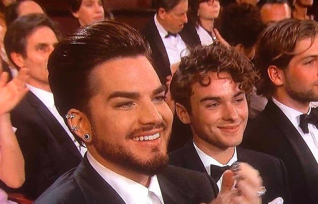 Javi and Adam smiling in an audience