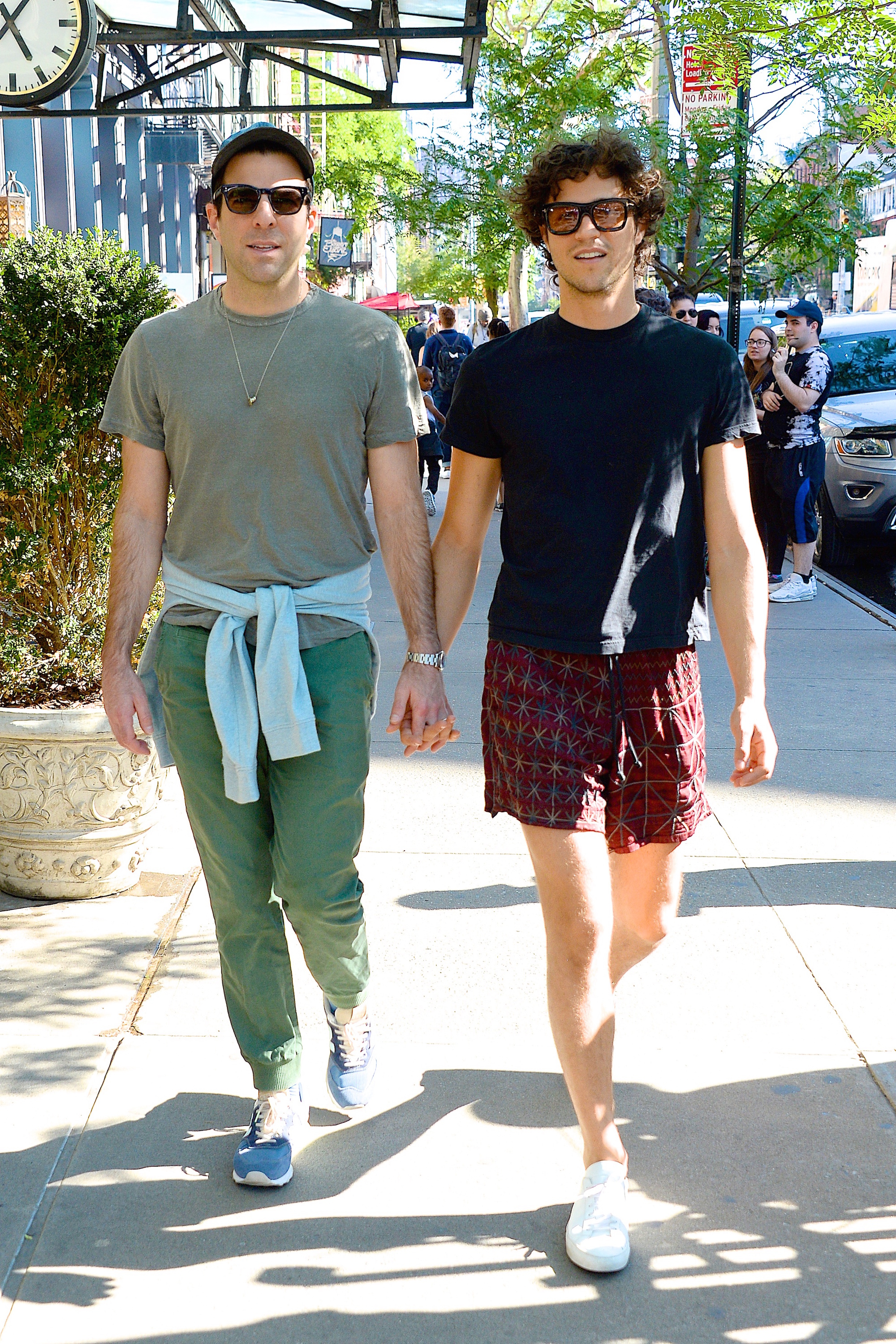 Miles and Zachary on the street holding hands