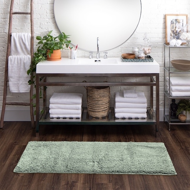 a green cotton bath mat