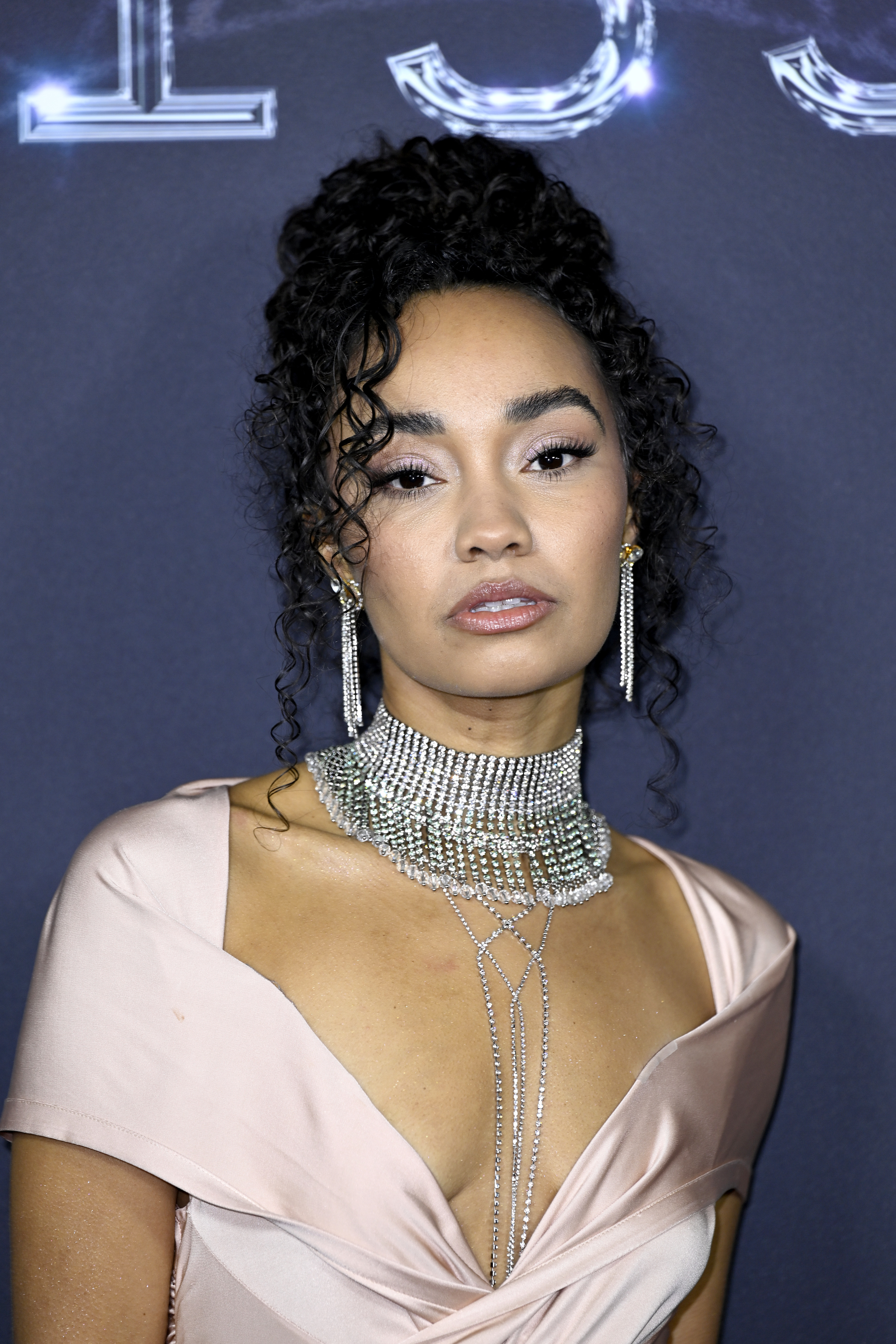 Leigh-Anne in a pink off-the-shoulder outfit and thick bejeweled choker and earrings