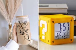 a glass can with ice coffee in it that says "Hannah" with roses on it and a Super Mario power up box alarm clock