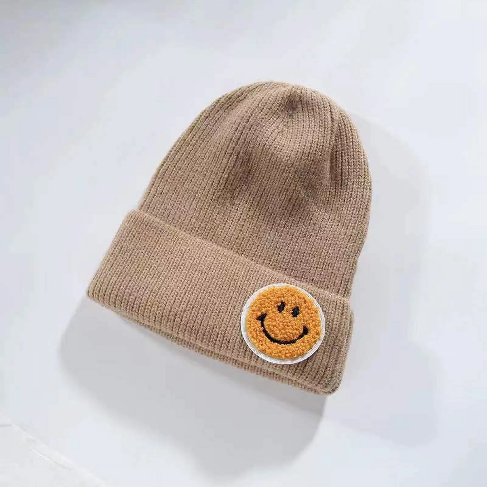 beige beanie with smiley face patch