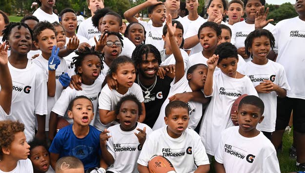 Colorado Buffaloes quarteback Shedeur Sanders, center, gets mobbed by kids as they get their photo taken on the practice fields at Fred Thomas Park in Denver, Colorado on July 24, 2023.