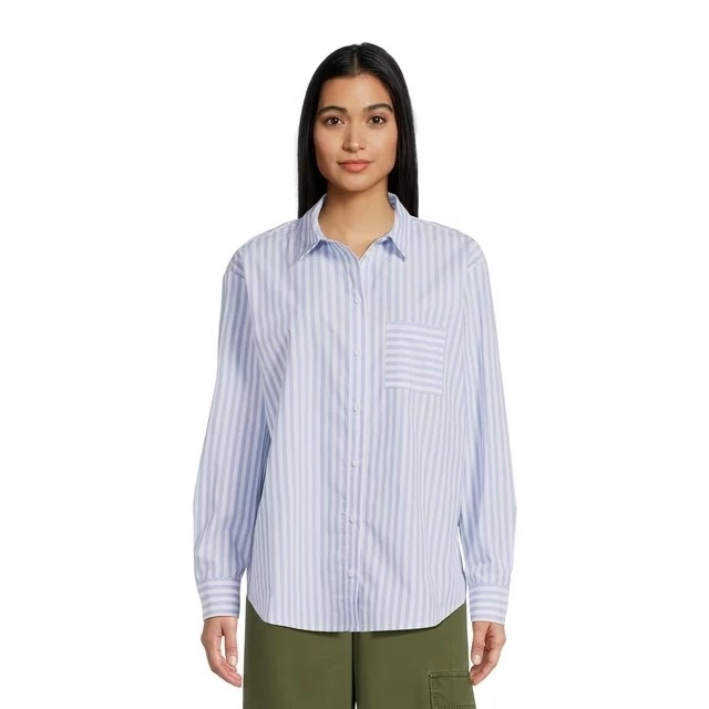 a model wearing on oversized button up shirt with blue and white stripes