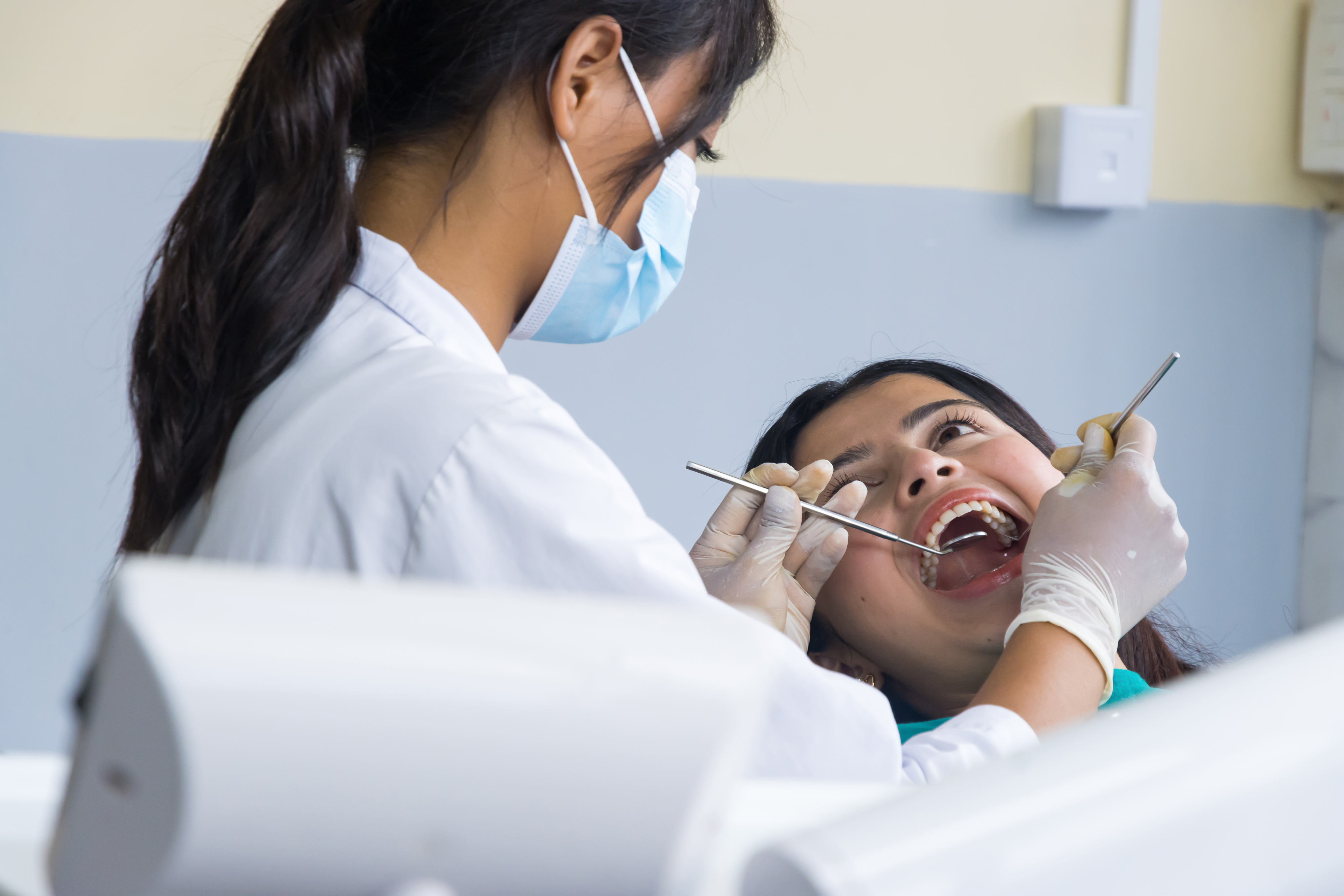 A dentist performing an exam on a patient