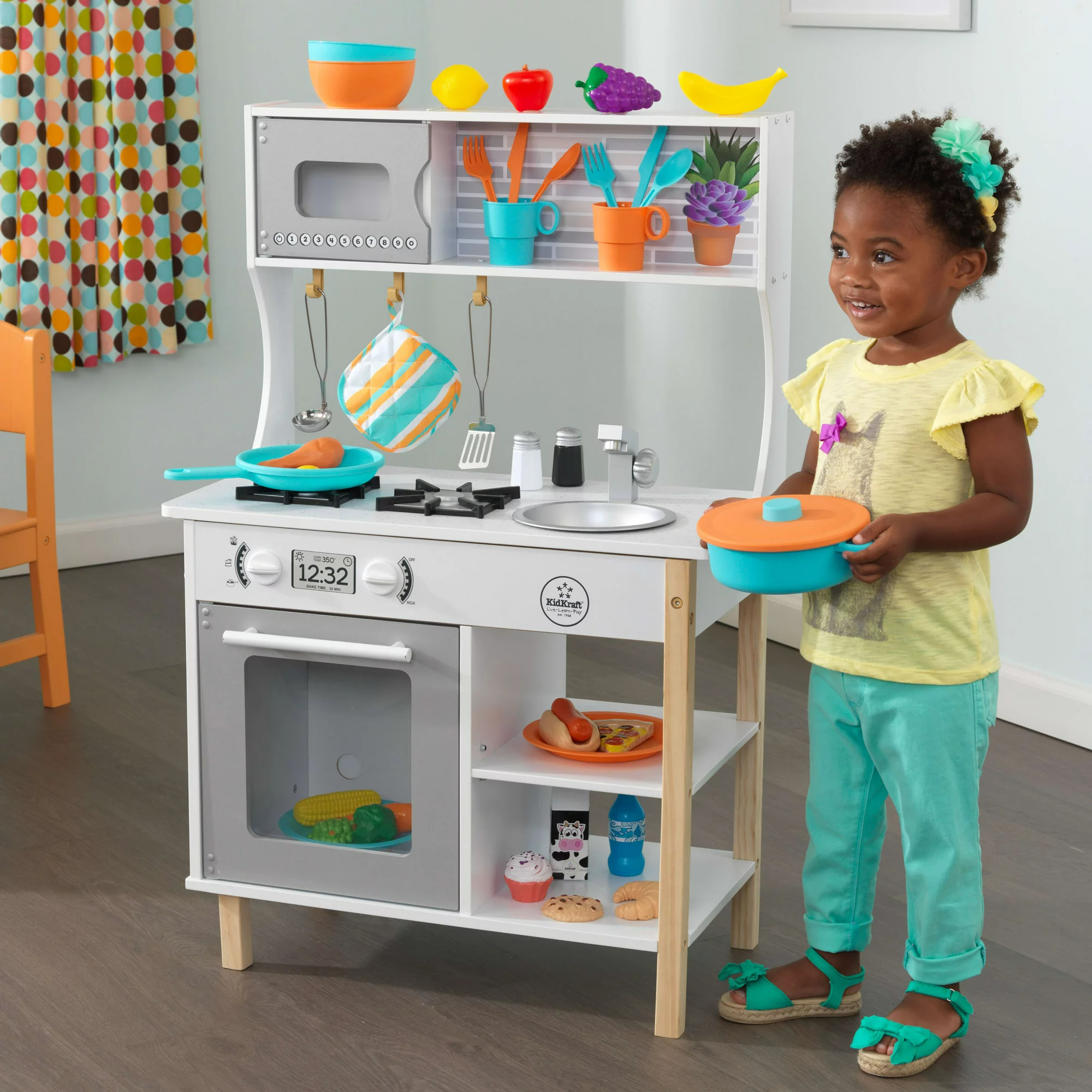 Child interacting with kitchen playset