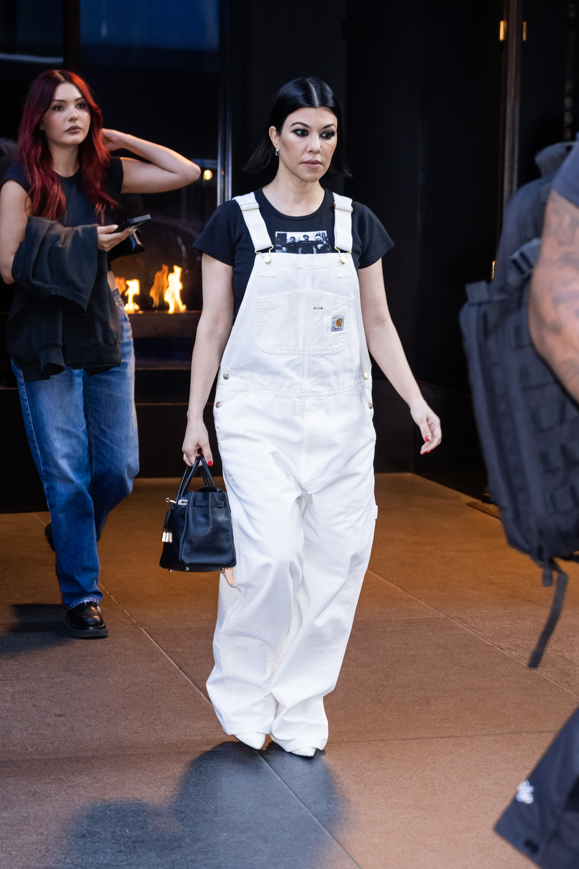 Close-up of Kourtney wearing overalls