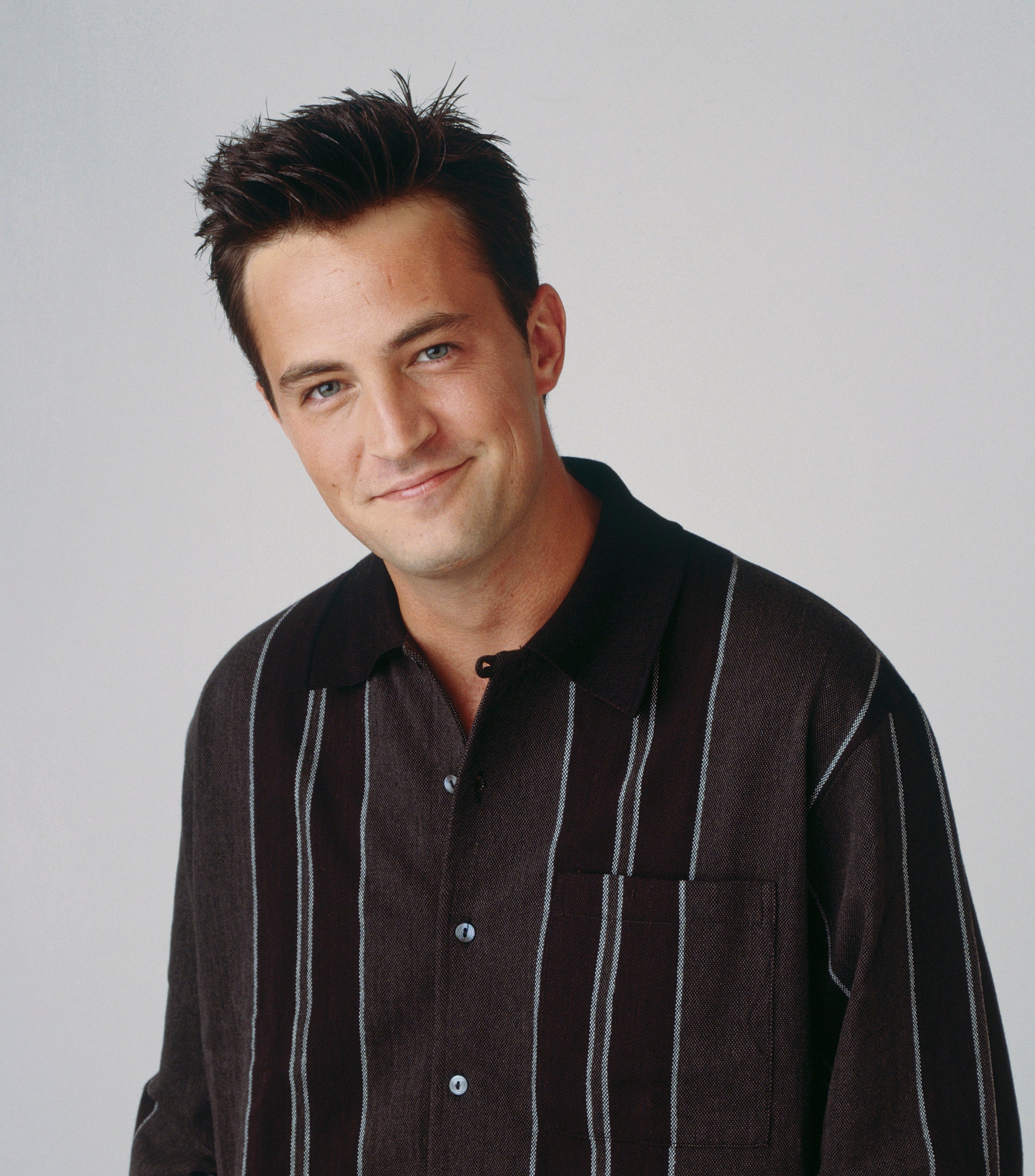 Matthew Perry smiles in a promo shot
